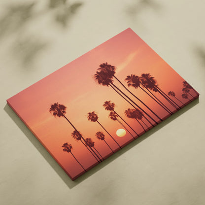 Canvas wall art featuring tall palm tree silhouettes against a warm orange and pink tropical sunset.
