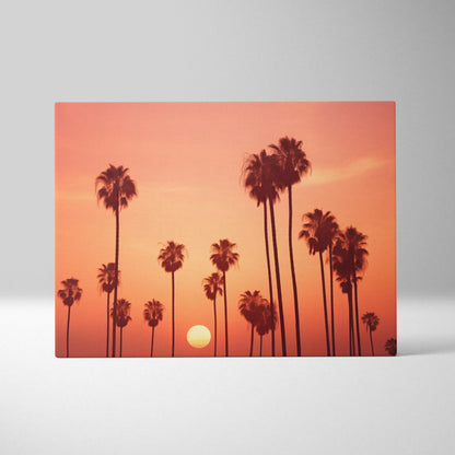 Canvas art print featuring black palm tree silhouettes against a vibrant orange and pink sunset sky.