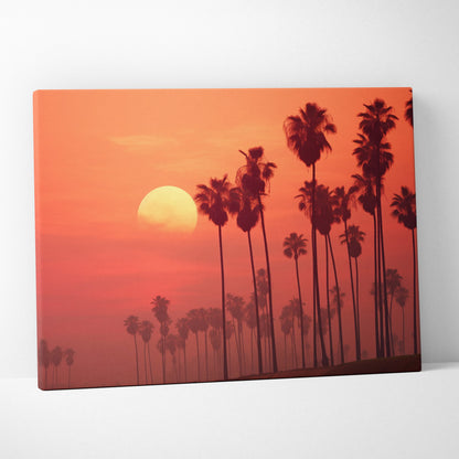 Canvas wall art featuring digital art of tropical palm tree silhouettes against a vibrant orange sunset decor.