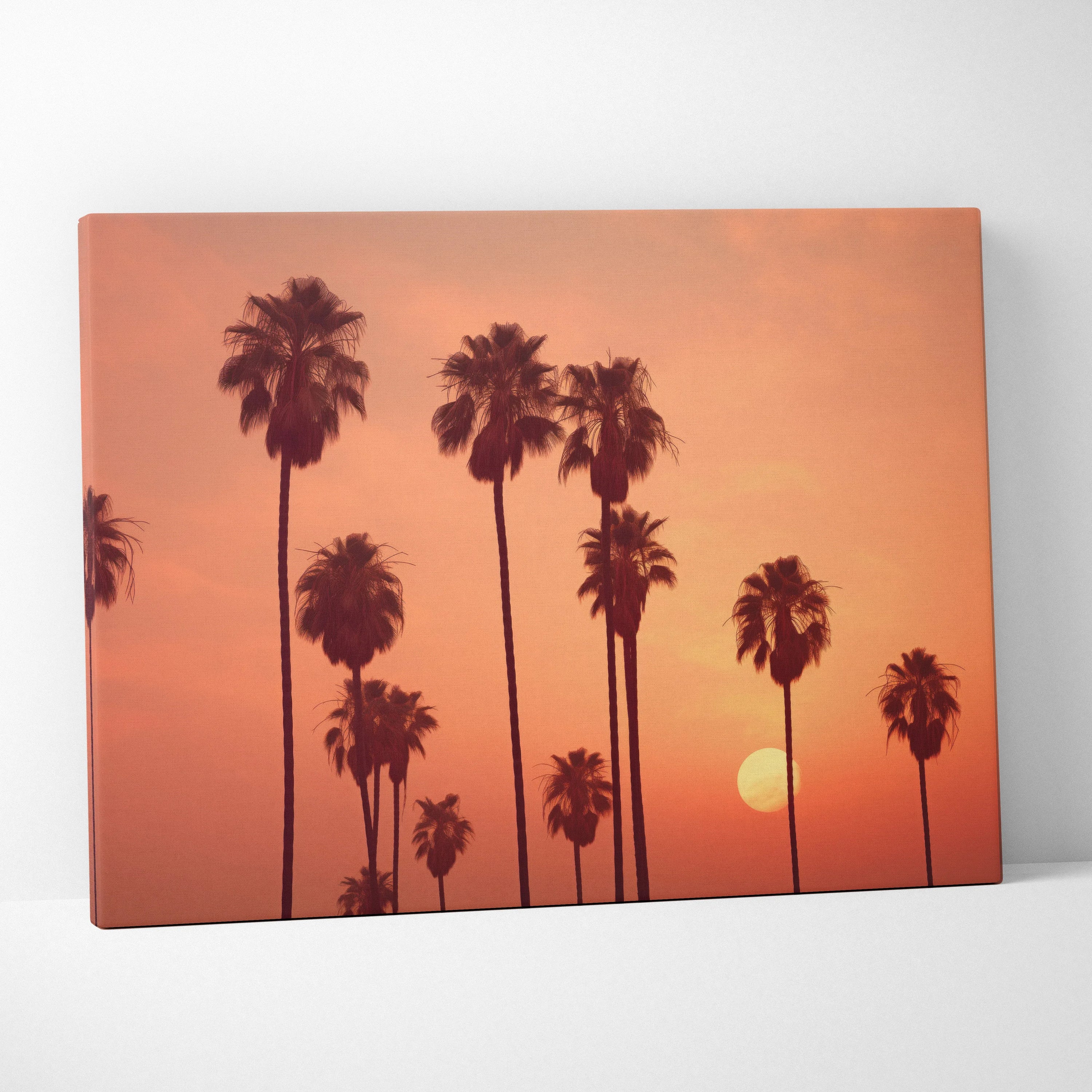Tropical palm trees silhouette canvas wall art with orange sunset sky decor.