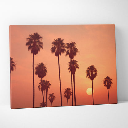 Tropical palm trees silhouette canvas wall art with orange sunset sky decor.