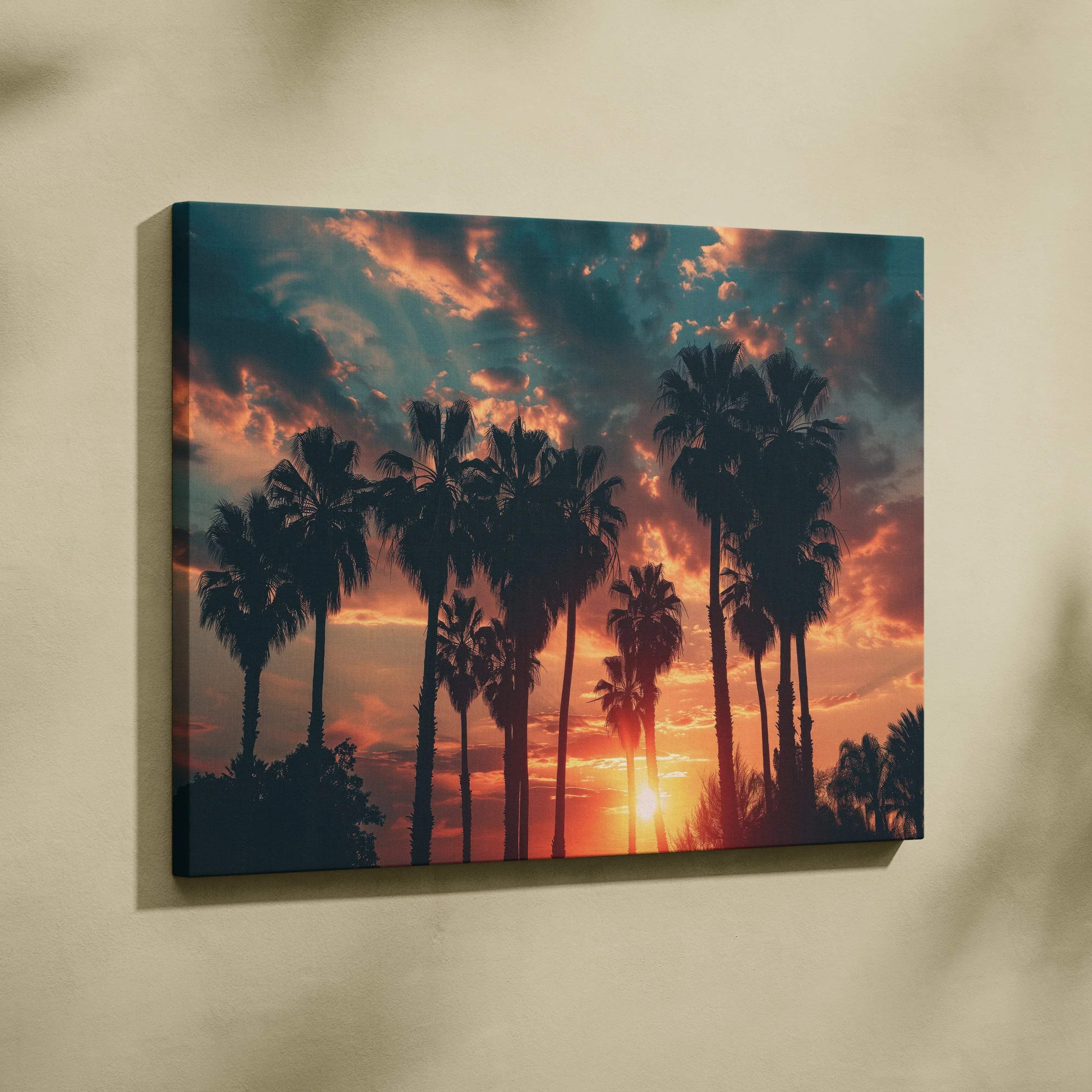 A rectangular canvas print featuring silhouetted palm trees against a vibrant orange and deep blue sunset sky for living room decor