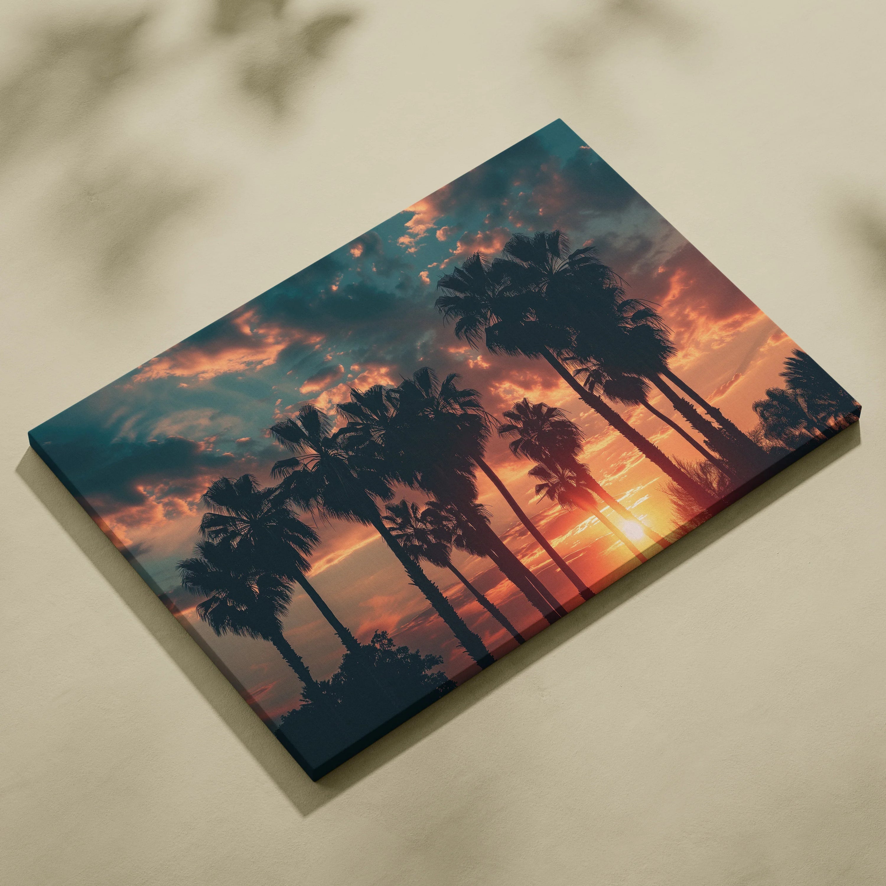 Canvas wall art featuring black palm tree silhouettes against a vibrant orange and blue tropical sunset sky.