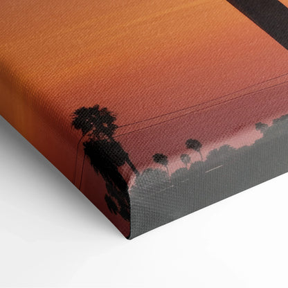Canvas art featuring black palm tree silhouettes against a gradient sunset background with warm orange and red tones.