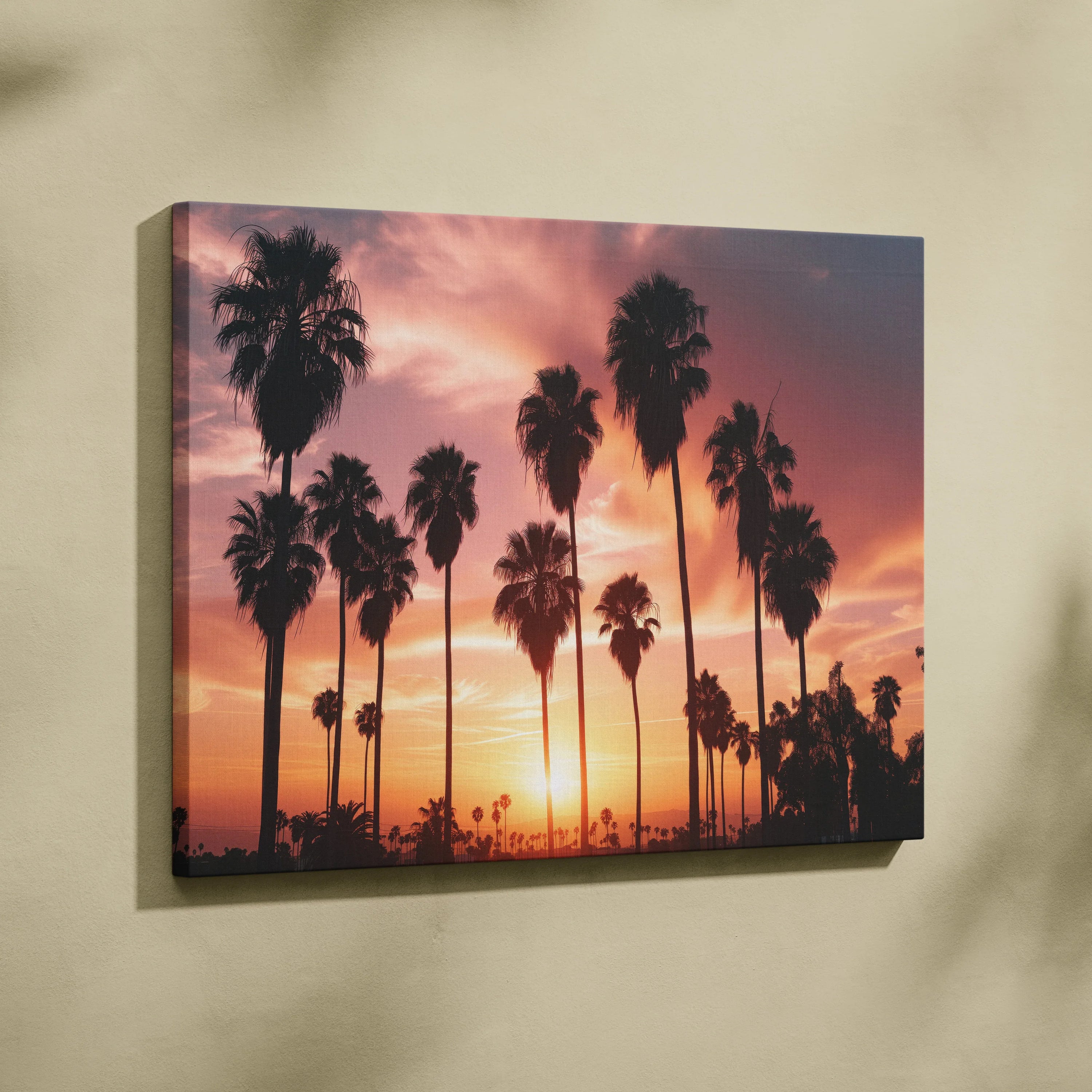 Canvas wall art featuring black palm tree silhouettes against a vibrant orange and purple sunset sky.