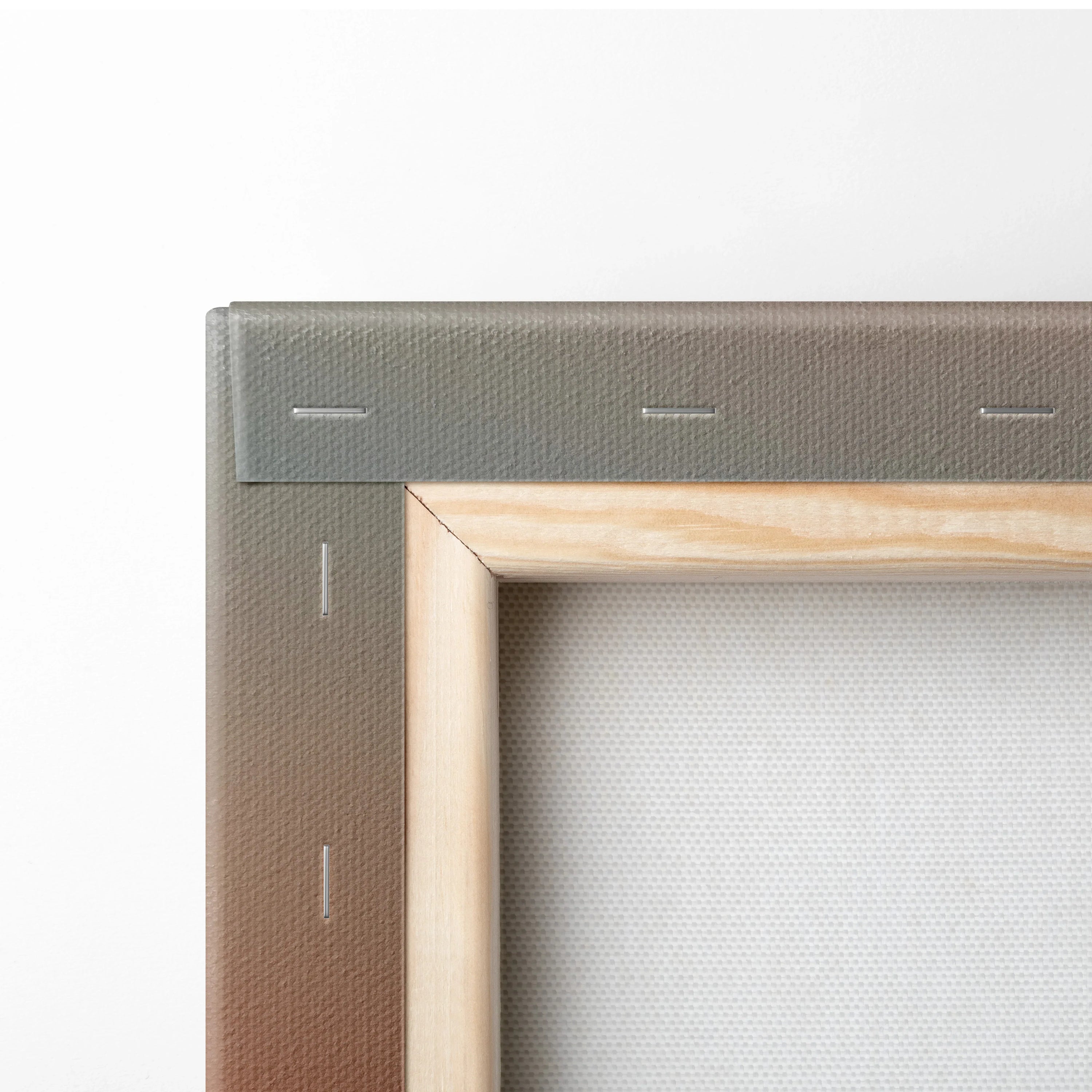 Close-up of stretched canvas corner with wooden frame and metal staples for wall art.