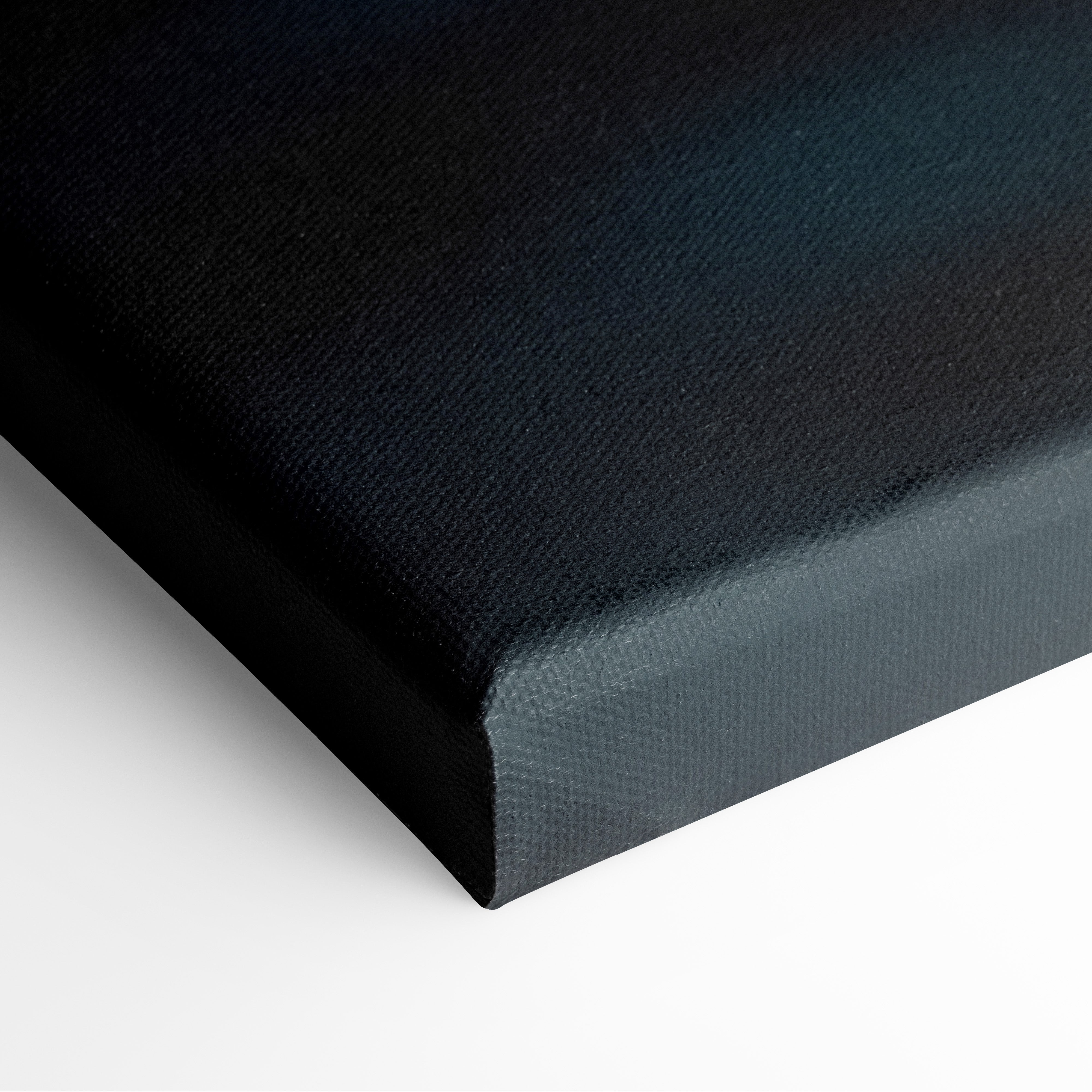 Close-up of stretched canvas corner with black and dark blue tones, highlighting textured art surface and wrapped edges of.