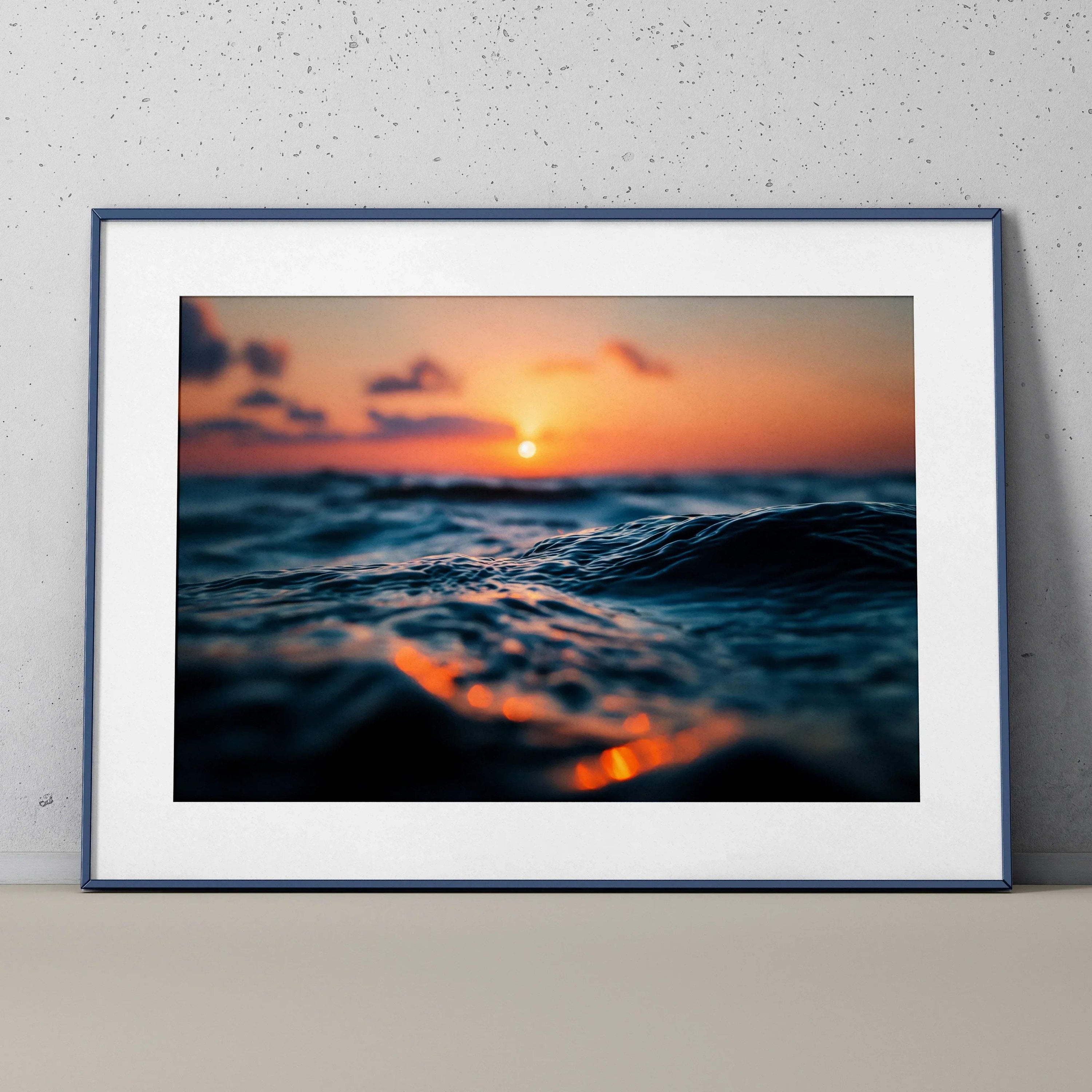 Ocean sunset wall art poster with close-up waves and vibrant orange and blue tones.
