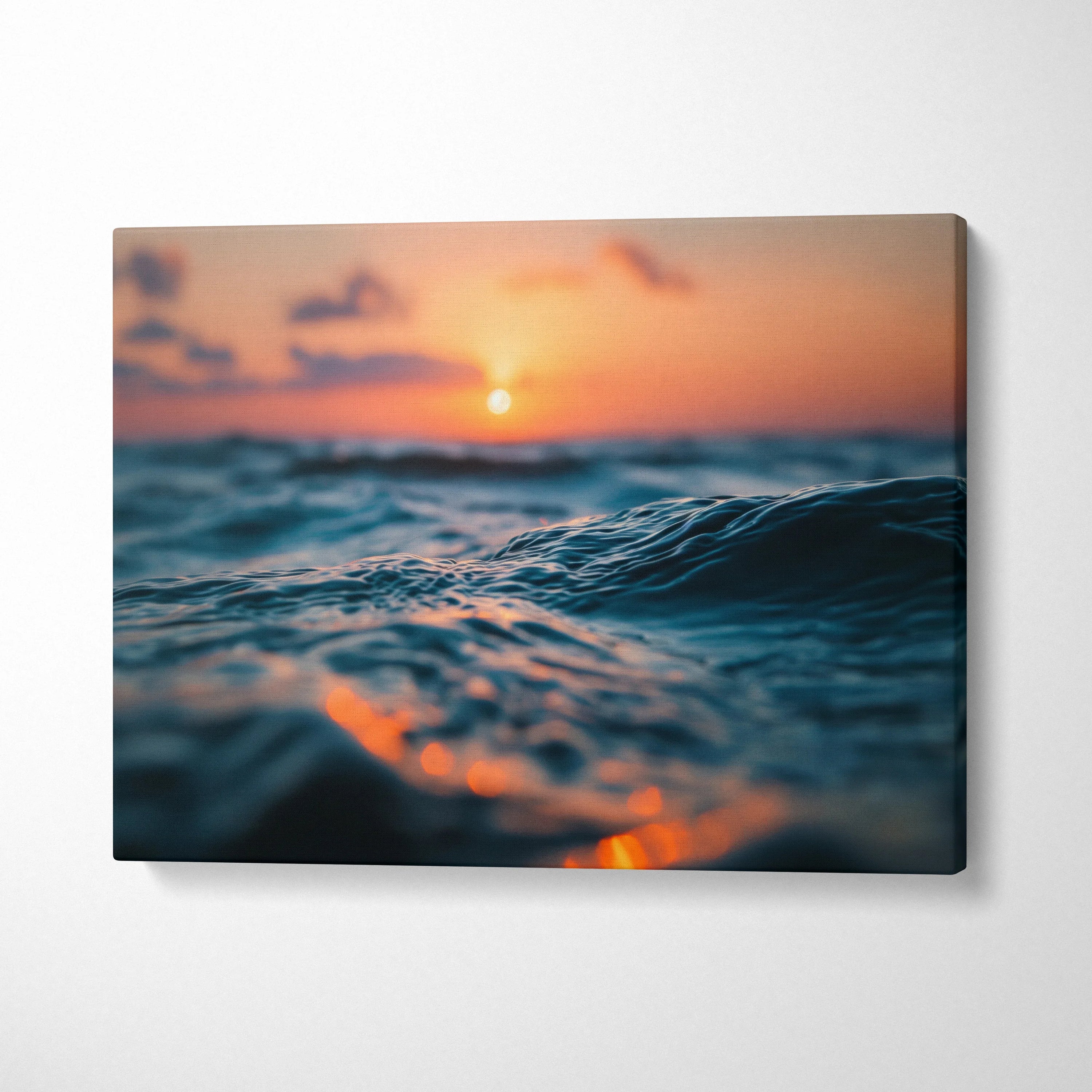 Canvas wall art featuring a golden sunset over ocean waves with vibrant orange and blue tones.