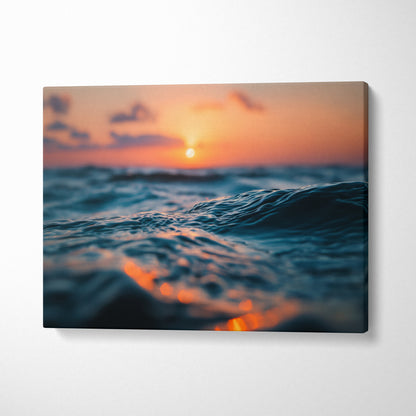 Canvas wall art featuring a golden sunset over ocean waves with vibrant orange and blue tones.