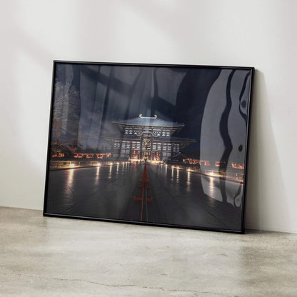 Dark night city building art poster with illuminated walkway, modern wall art in black frame.