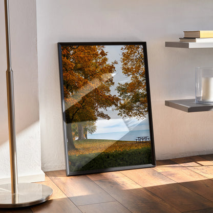 Vertical autumn nature art poster with golden and orange leaves by calm lake, framed wall art.