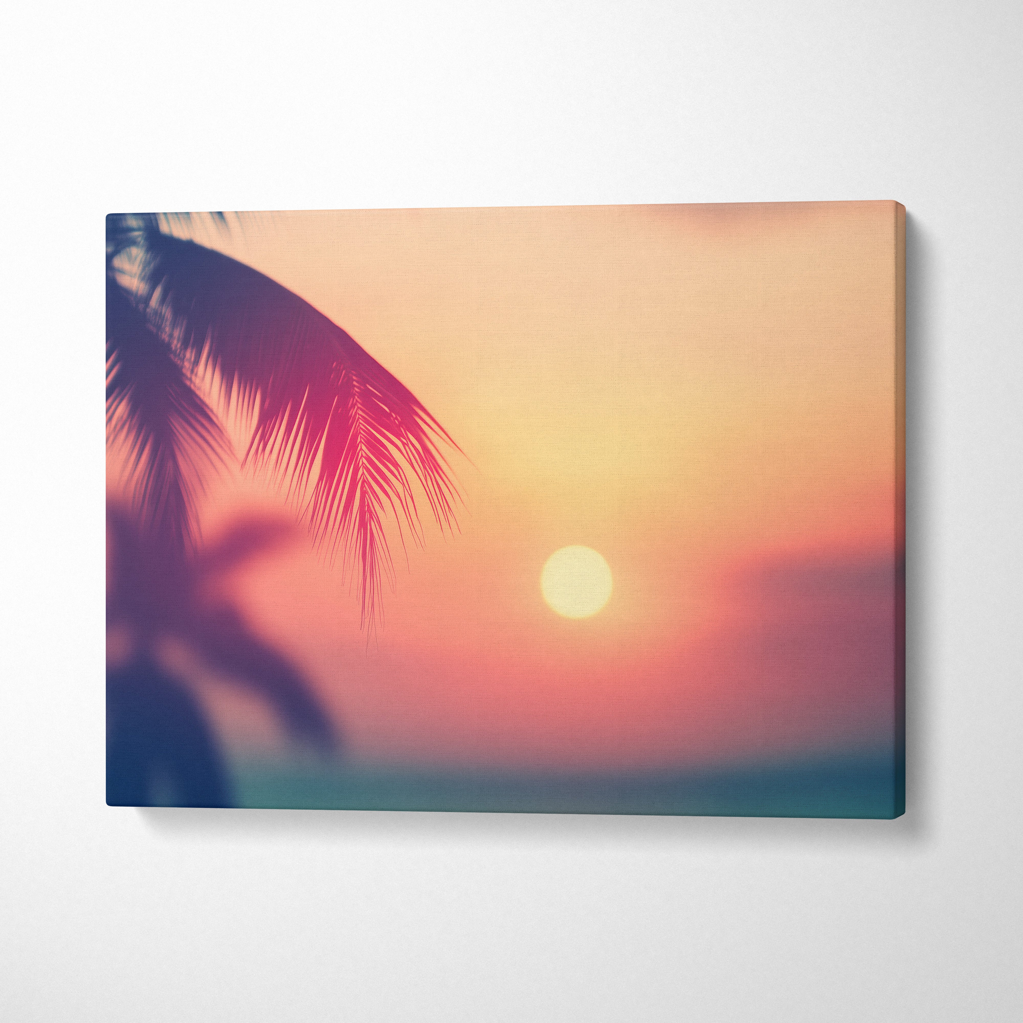 Sunset beach scene with palm silhouette in warm pink and orange tones on canvas wall art.