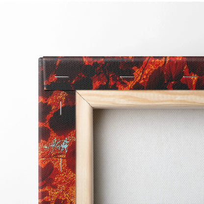 Close-up of vibrant autumn forest canvas wall art corner with wooden frame edges and textured surface.