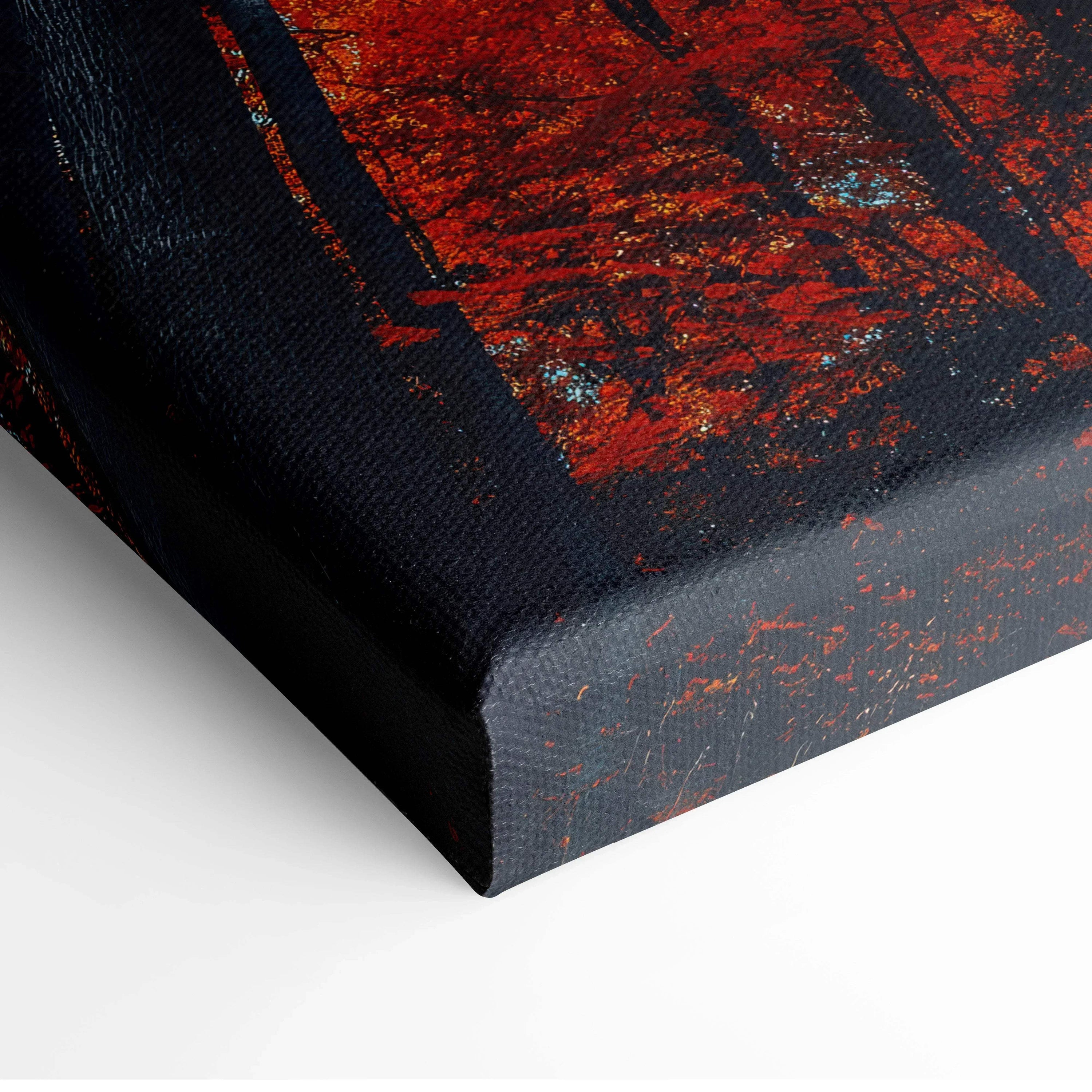 Corner close-up of vibrant autumn forest canvas wall art showing rich red foliage and dark tree trunks.