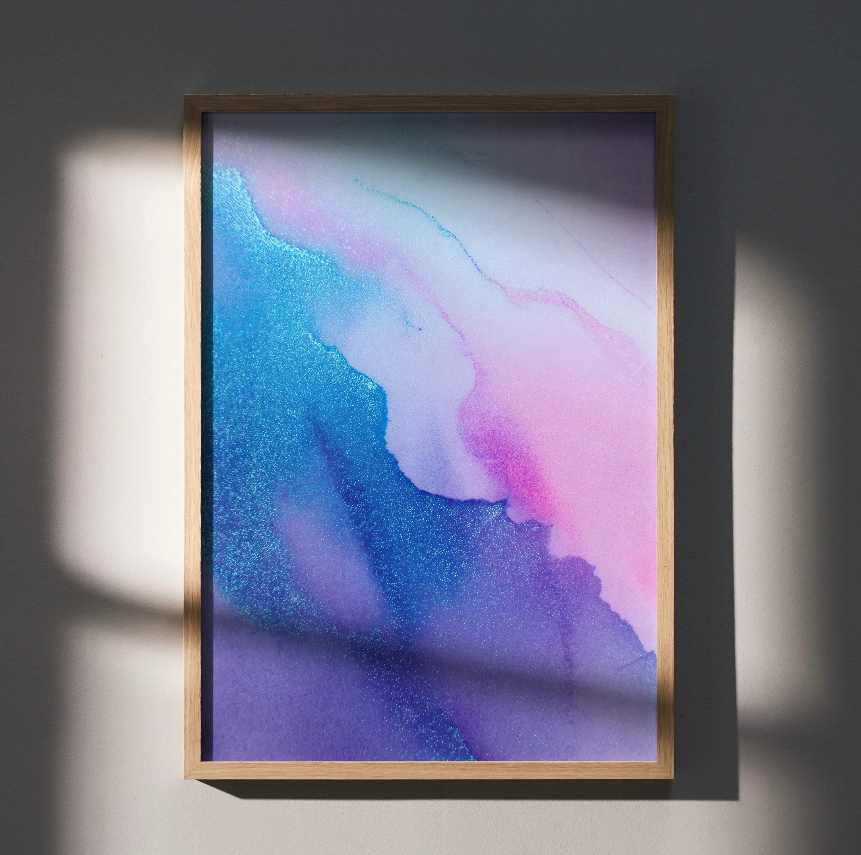 Modern abstract wall art poster with bold blue and pink digital patterns in a wooden frame.