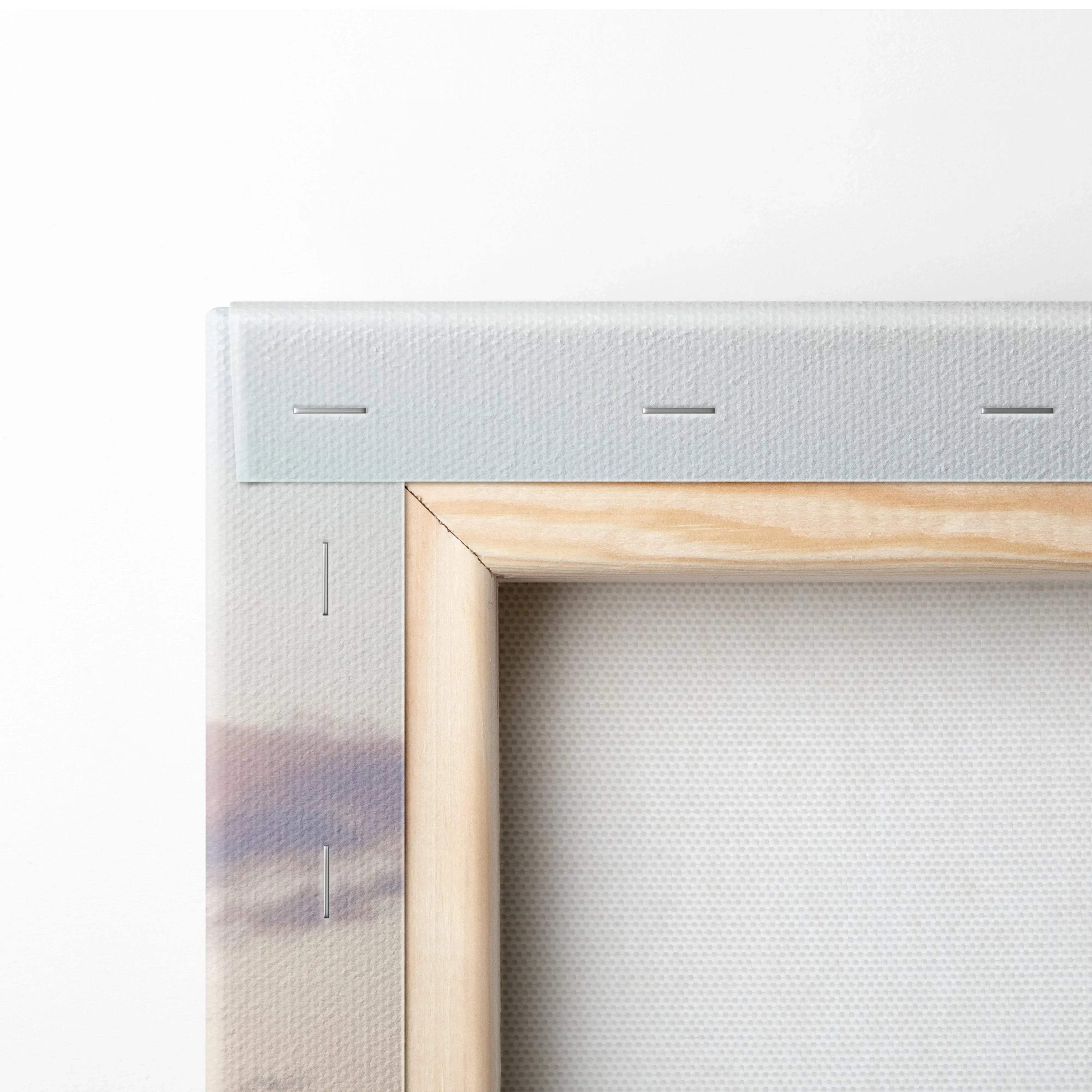 Close-up of wooden stretcher frame and canvas texture on mountain sunset wall art print.