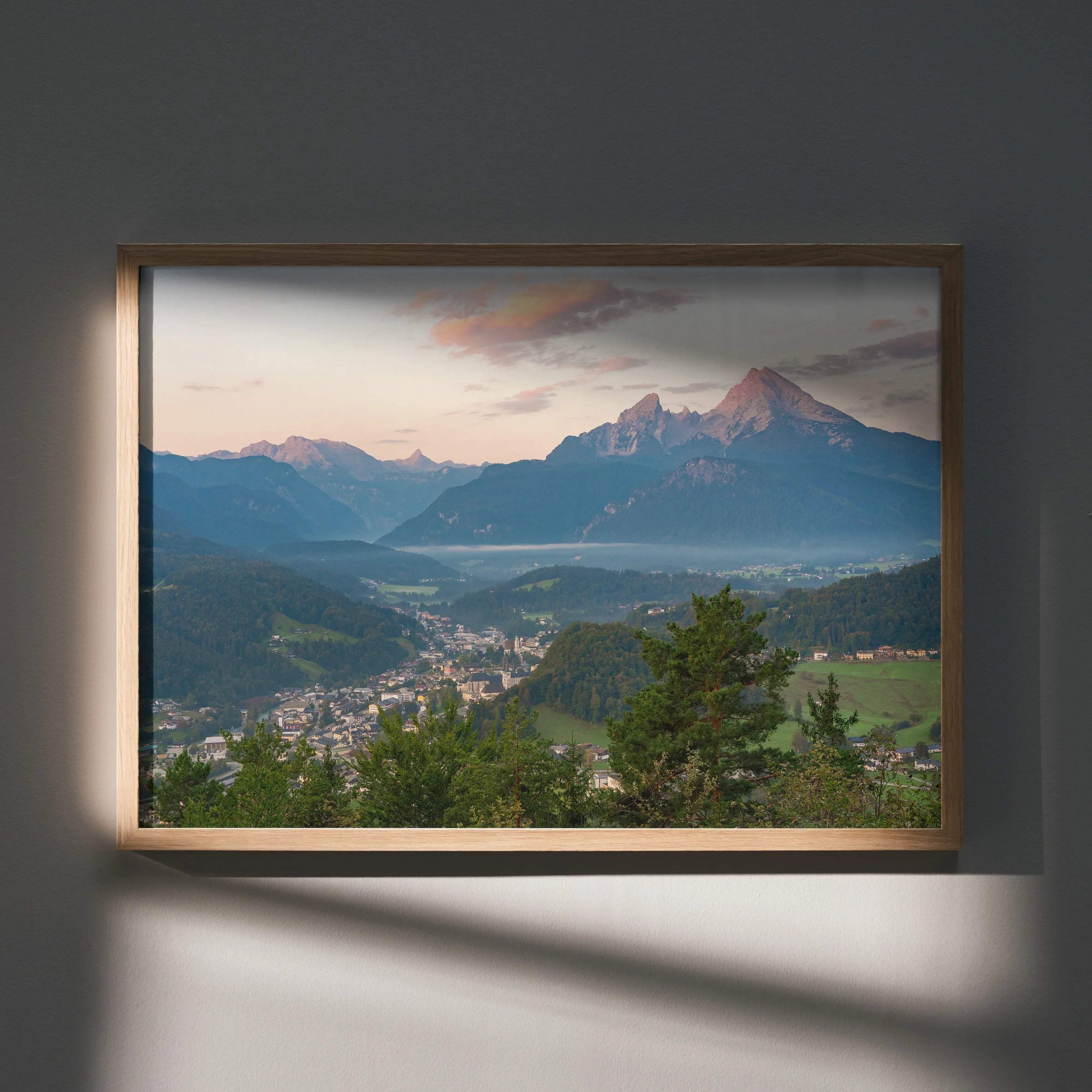 Mountain sunset wall art poster featuring glowing peaks and a village valley under a colorful sky.