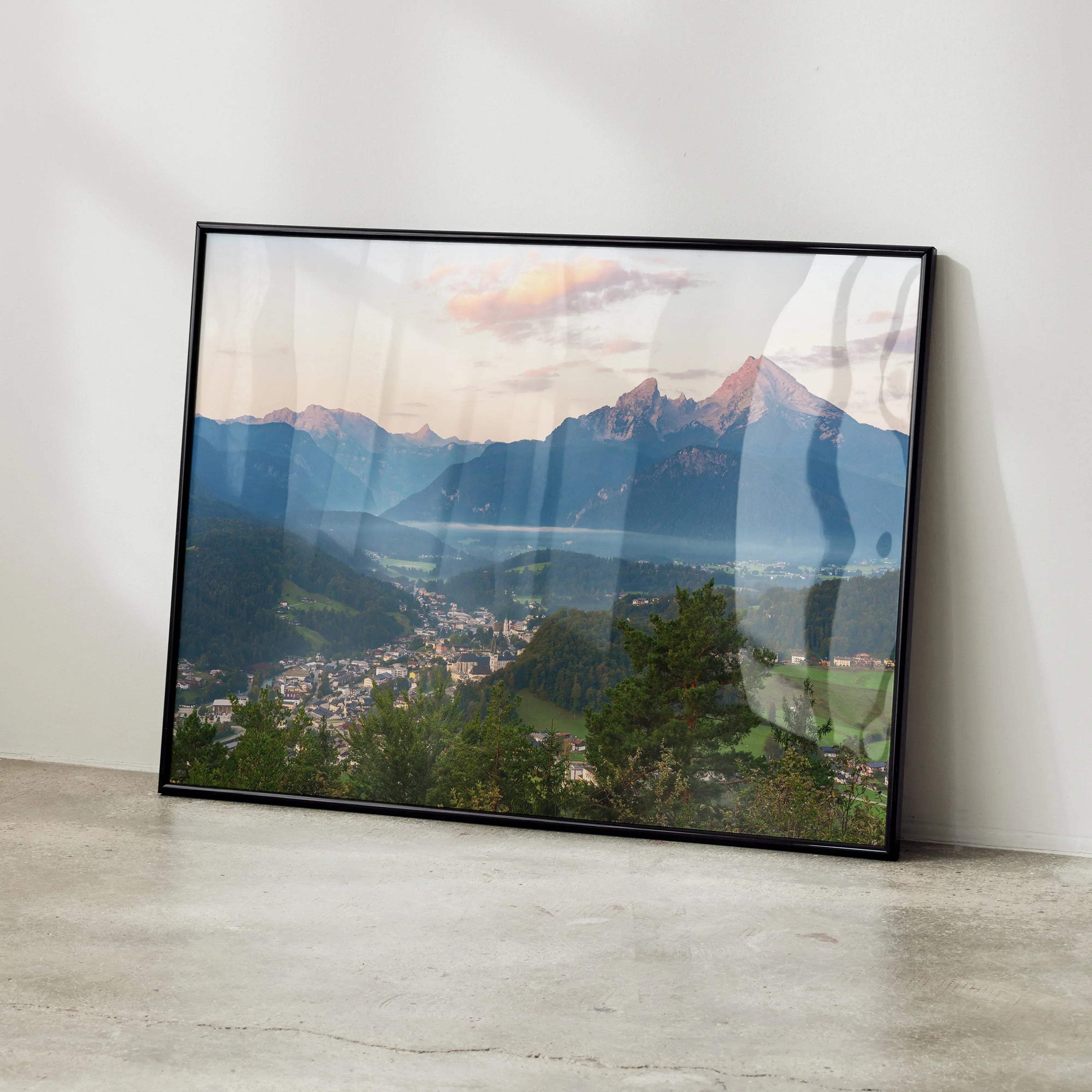 Mountain sunset wall art with vibrant orange and pink sky over dark blue peaks, framed poster.