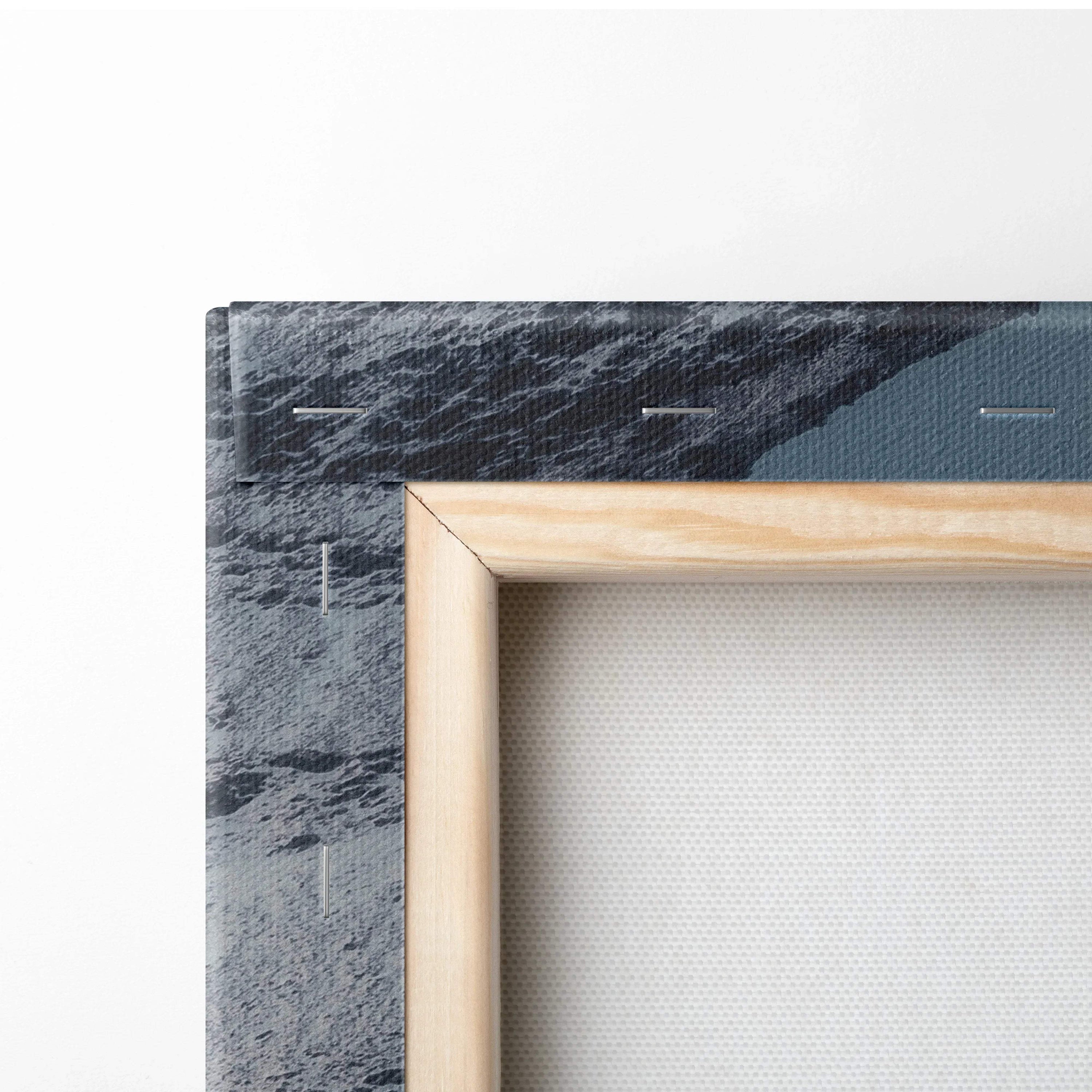 Close-up of wooden frame and textured canvas edge of vibrant sunset mountains wall art print.