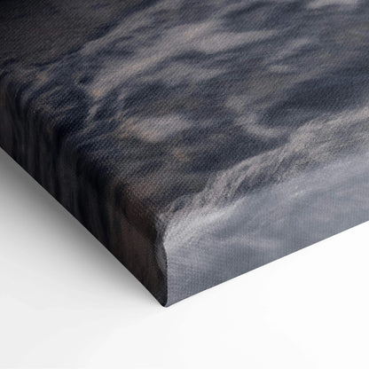 Close-up of canvas texture on vibrant sunset mountains wall art with rich dark and light tones.