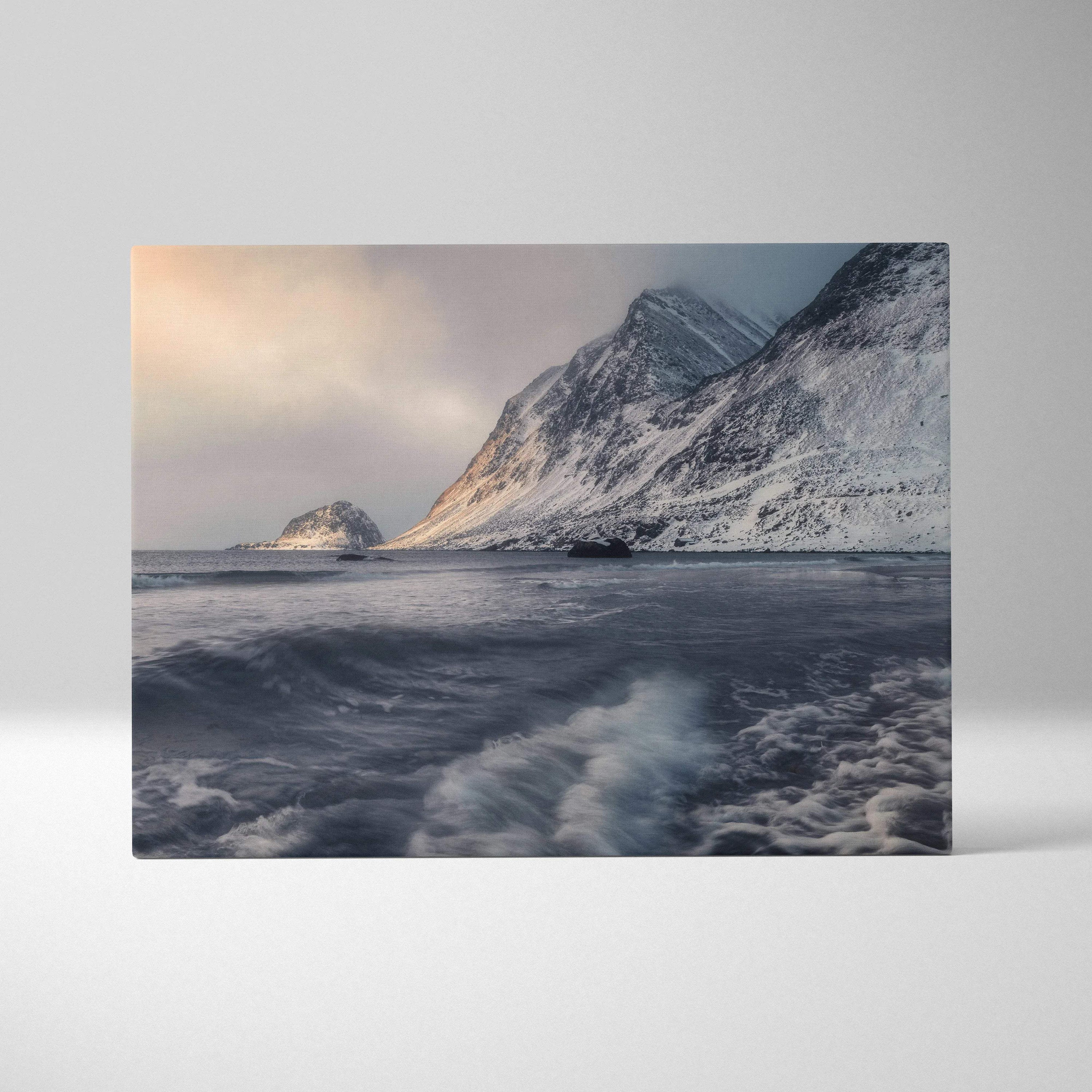Canvas wall art featuring snowy mountain peaks and turbulent ocean waves under a cloudy sky.