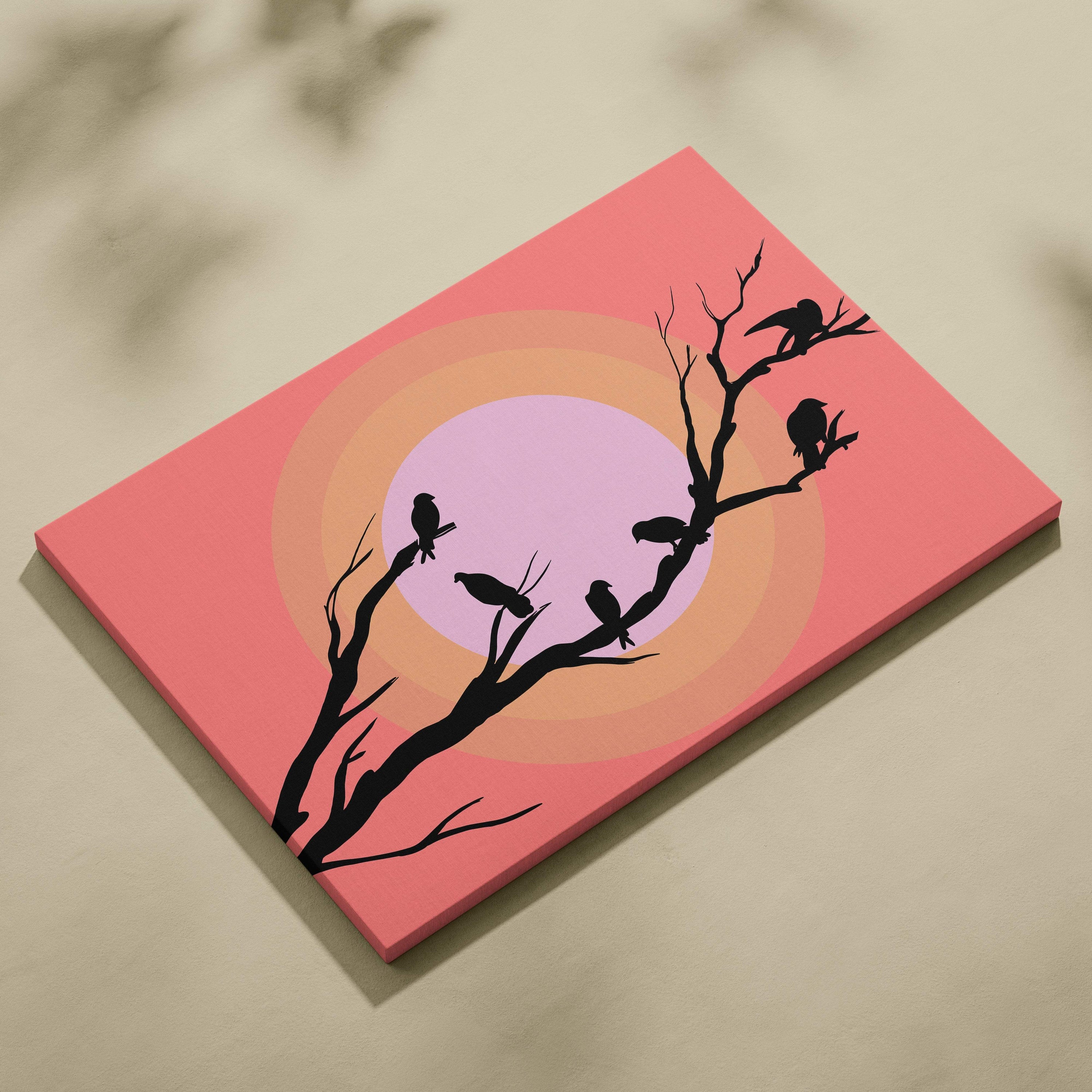 Pink canvas print of black bird silhouettes on bare branches with coral and pastel gradient background wall art decor