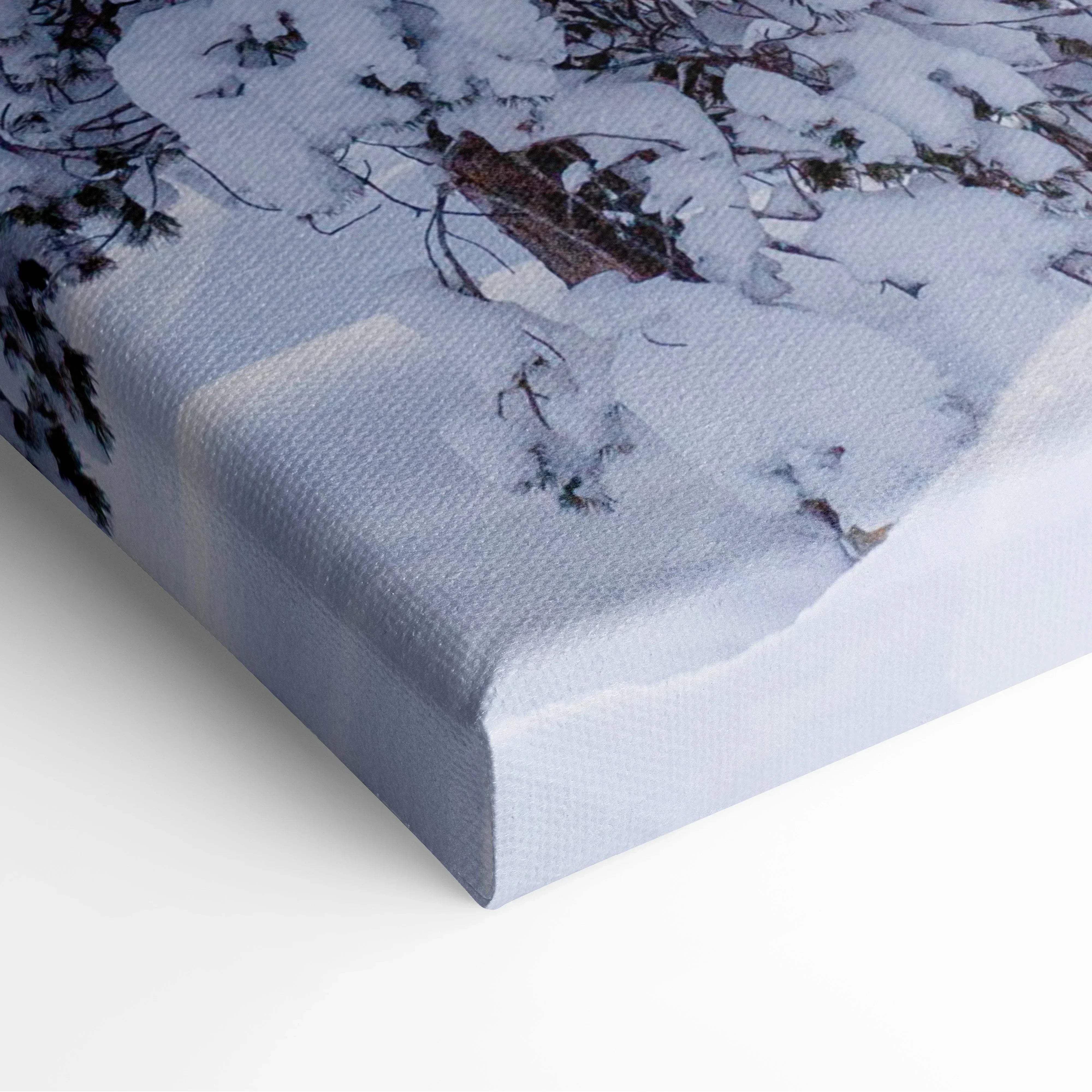 Winter landscape canvas wall art featuring a snow-covered forest with warm golden hour glow on textured canvas