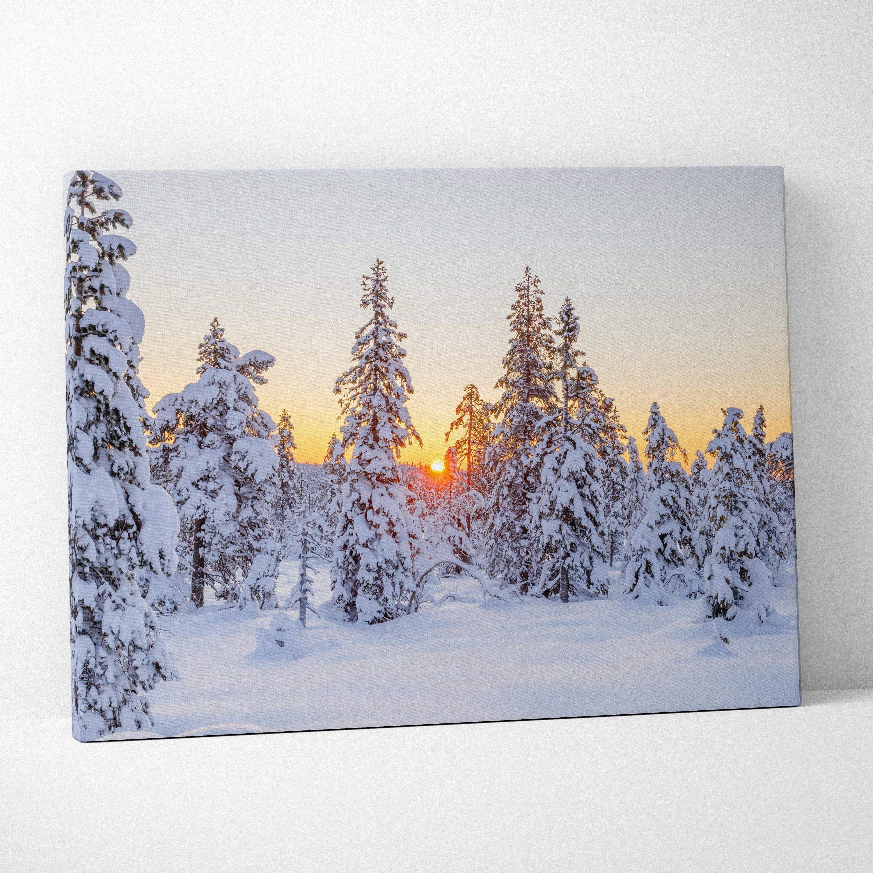 Snowy forest at sunset with warm sky hues on canvas wall art print.