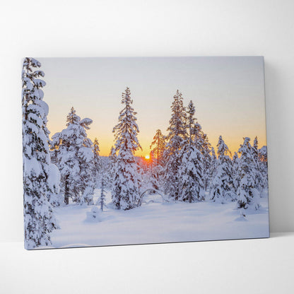 Snowy forest at sunset with warm sky hues on canvas wall art print.