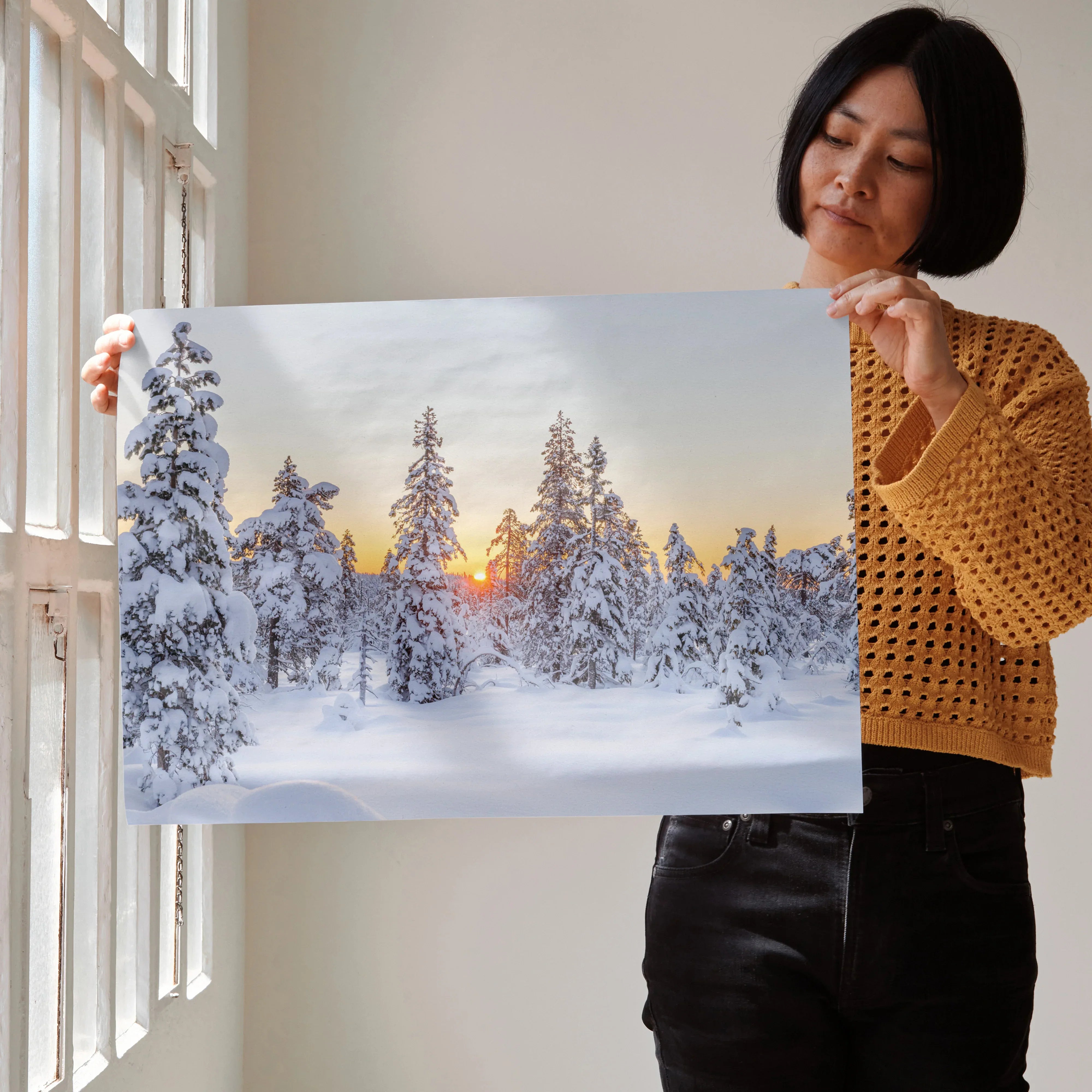 Serene snowy mountain landscape poster with sun setting behind snow-covered pine trees wall art.