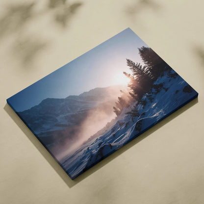 Blue canvas print of serene winter sunrise over snowy mountains and pine forest