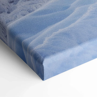 Canvas wall art featuring a soft, dreamy winter snow landscape in cool blue tones with subtle texture.