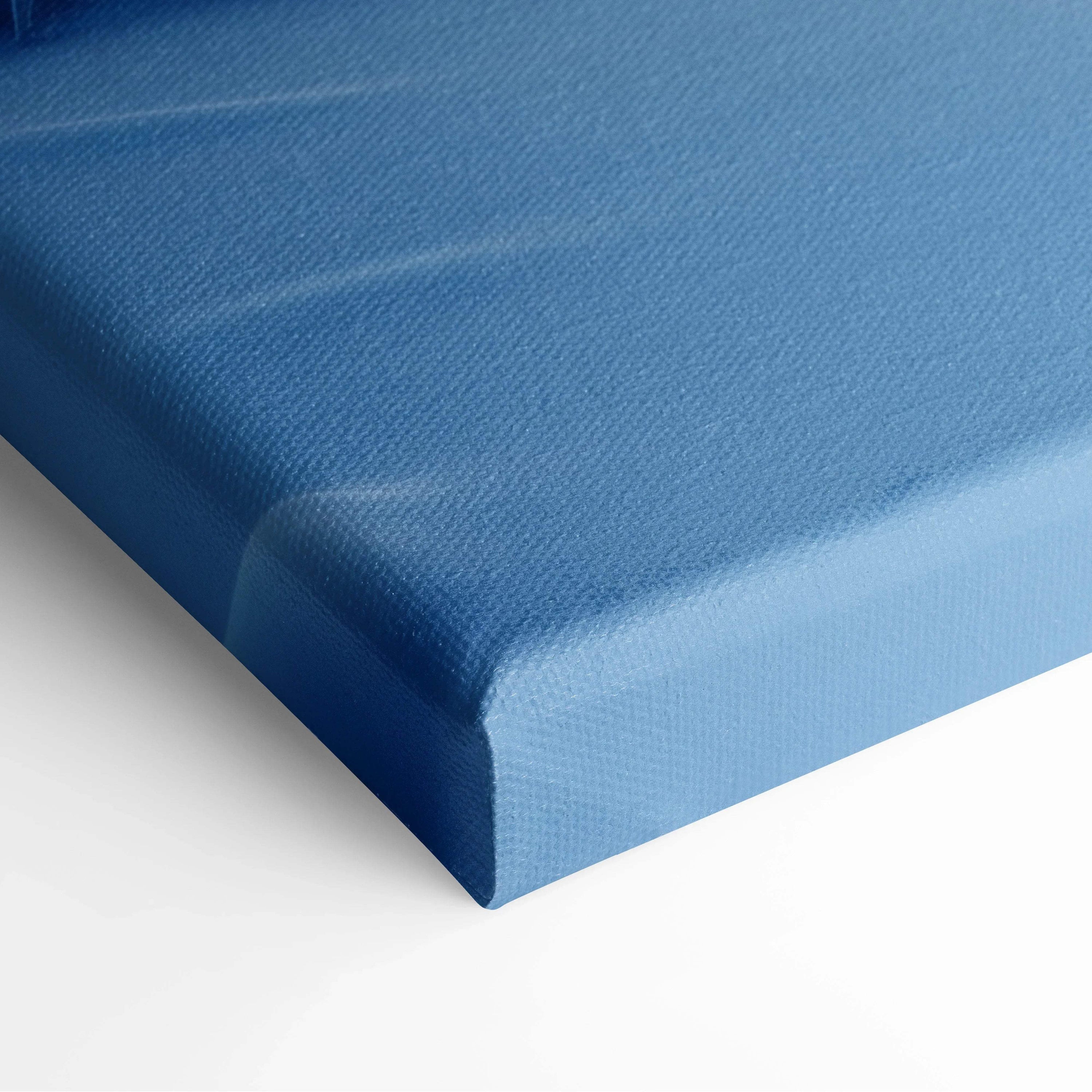 Blue wrapped canvas corner with textured fabric surface for digital wall art decor.
