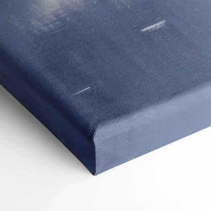 Close-up of a stretched canvas with deep blue and white snowy landscape print corner for wall art decor.