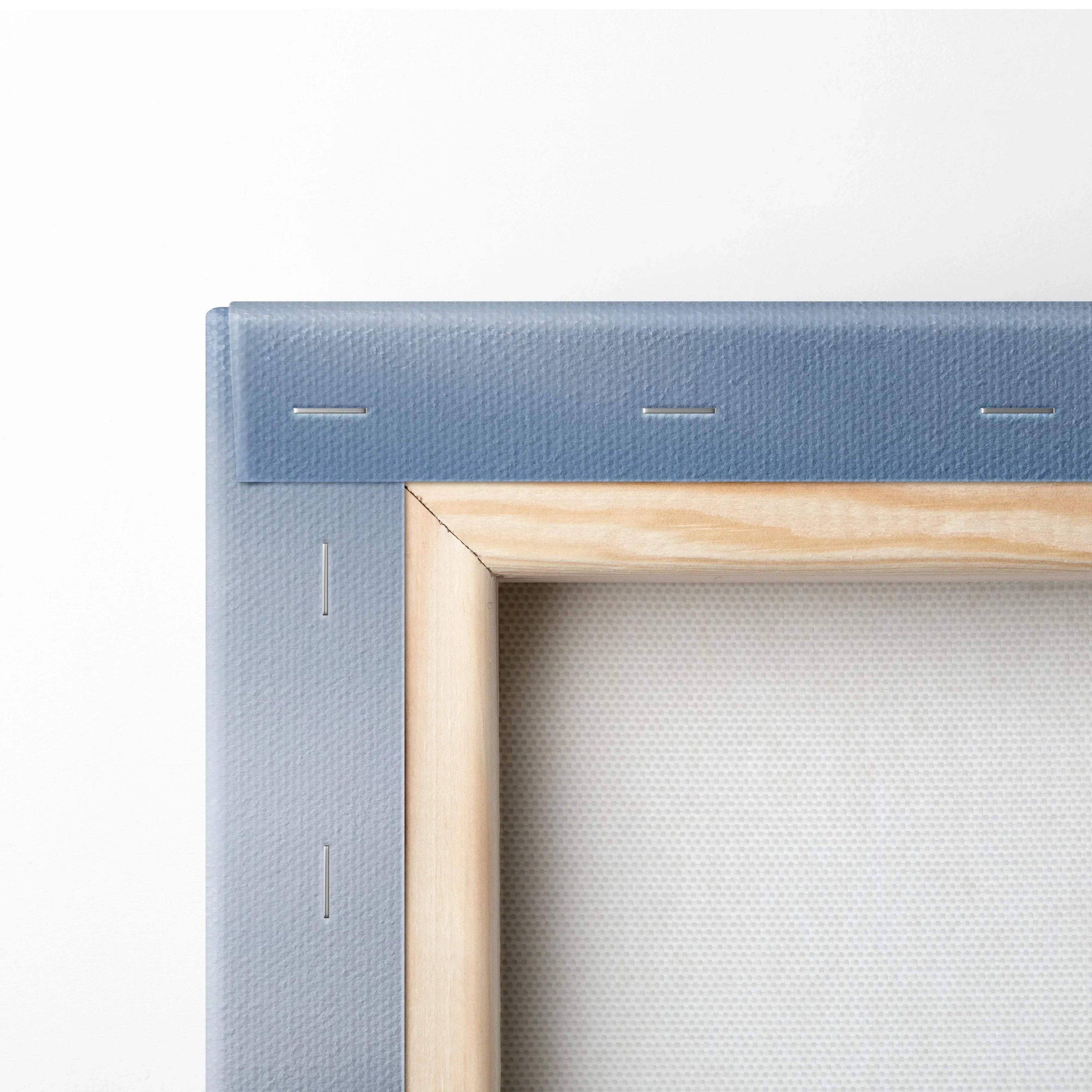 Close-up of blue canvas stretched and stapled over wooden frame for wall art decor.