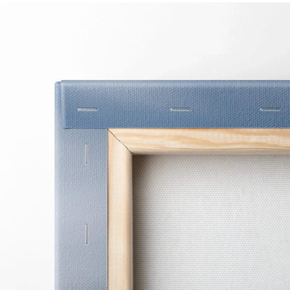 Close-up of blue canvas stretched and stapled over wooden frame for wall art decor.