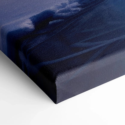 Close-up of wrapped canvas edge showing textured fabric and dark blue tones of snowy sunset winter landscape wall art.