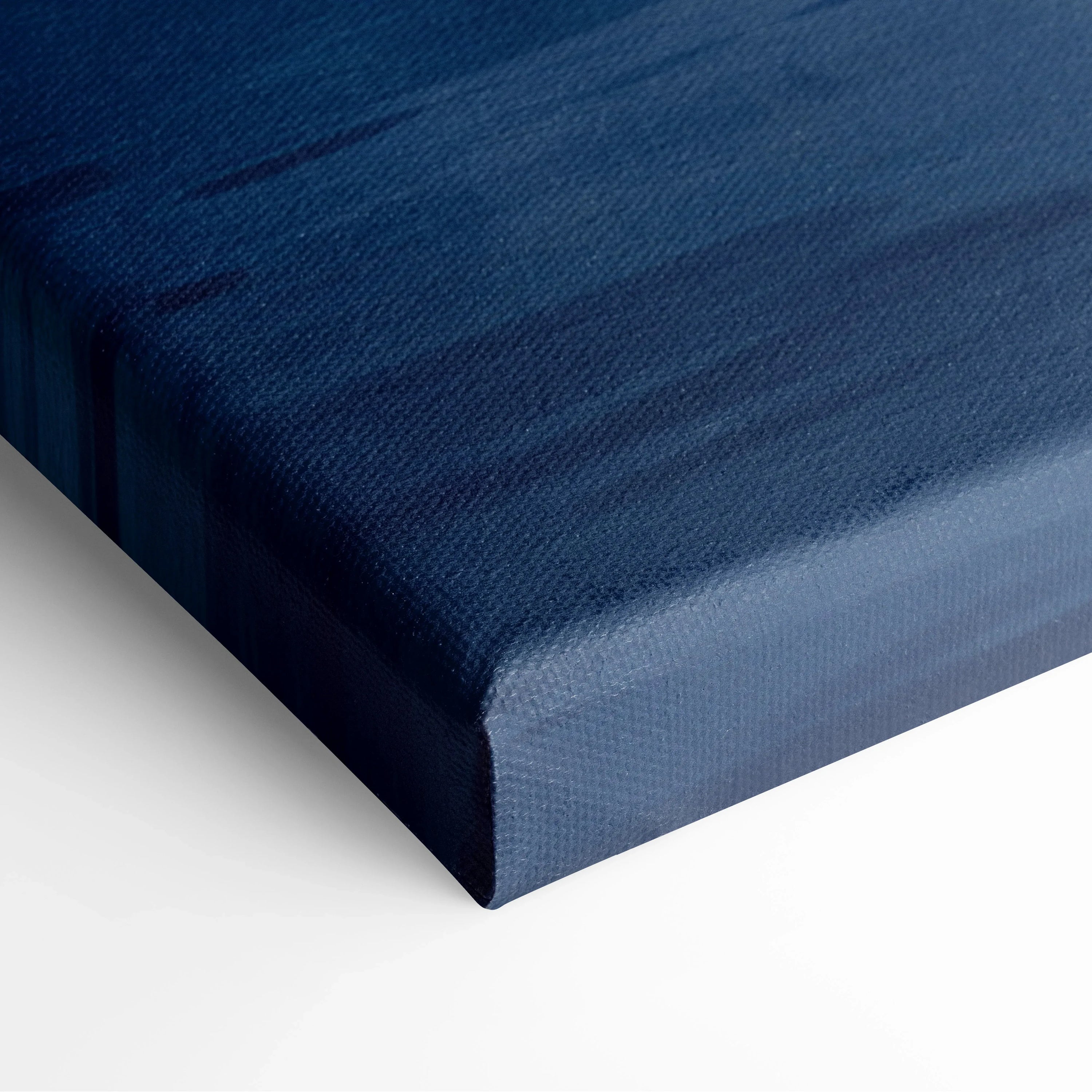 Blue canvas wall art with textured fabric wrap, showing a deep indigo color gradient on the edge.