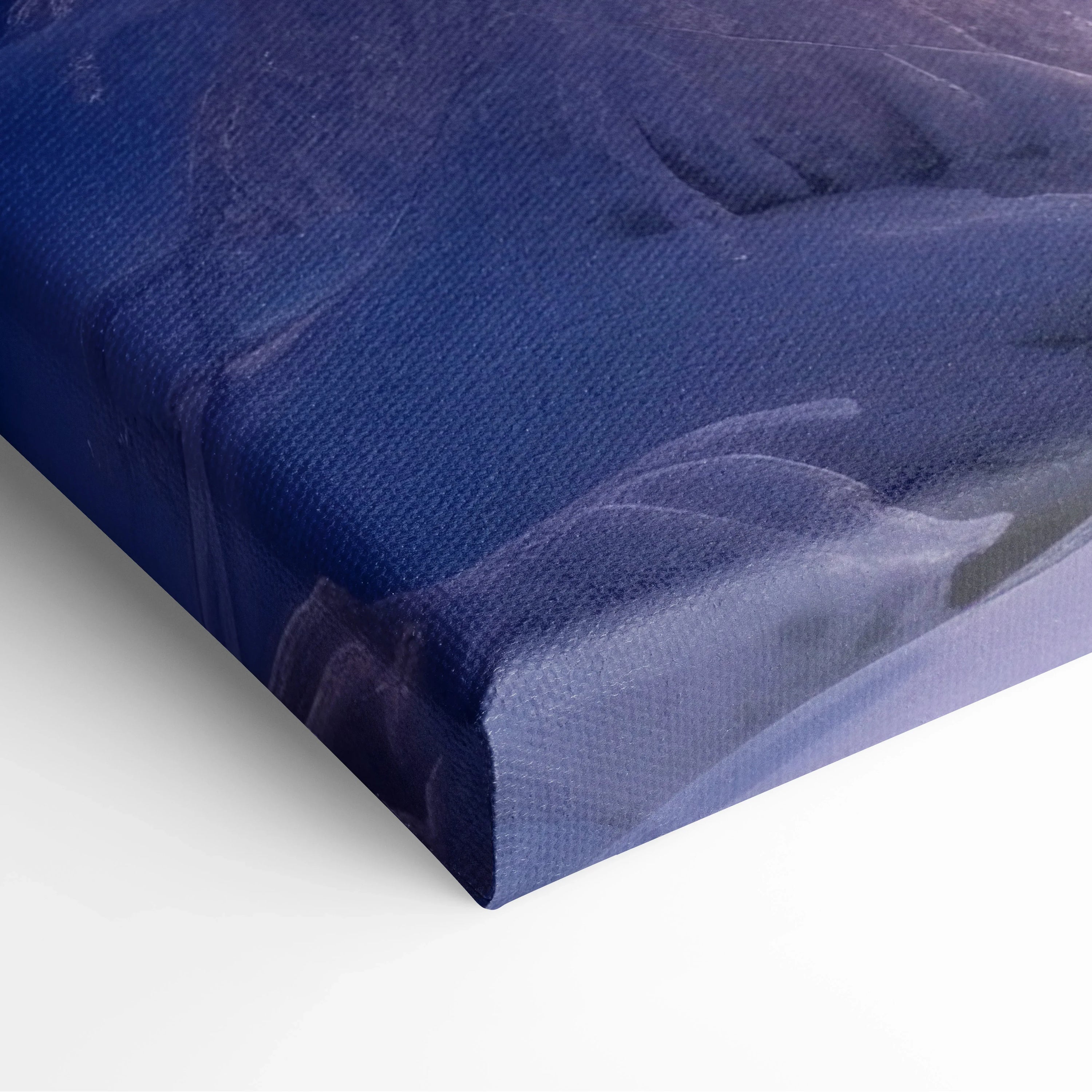 Close-up of blue and purple snowy sunset canvas wall art corner with textured fabric and gallery wrap design for home decor.