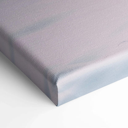 Close-up of a stretched canvas corner with soft pastel colors and textured fabric surface.