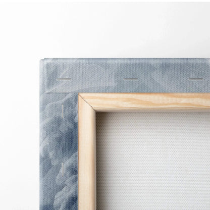 Close-up of a wooden framed canvas with white fabric stretched and stapled on the back for wall art decor.
