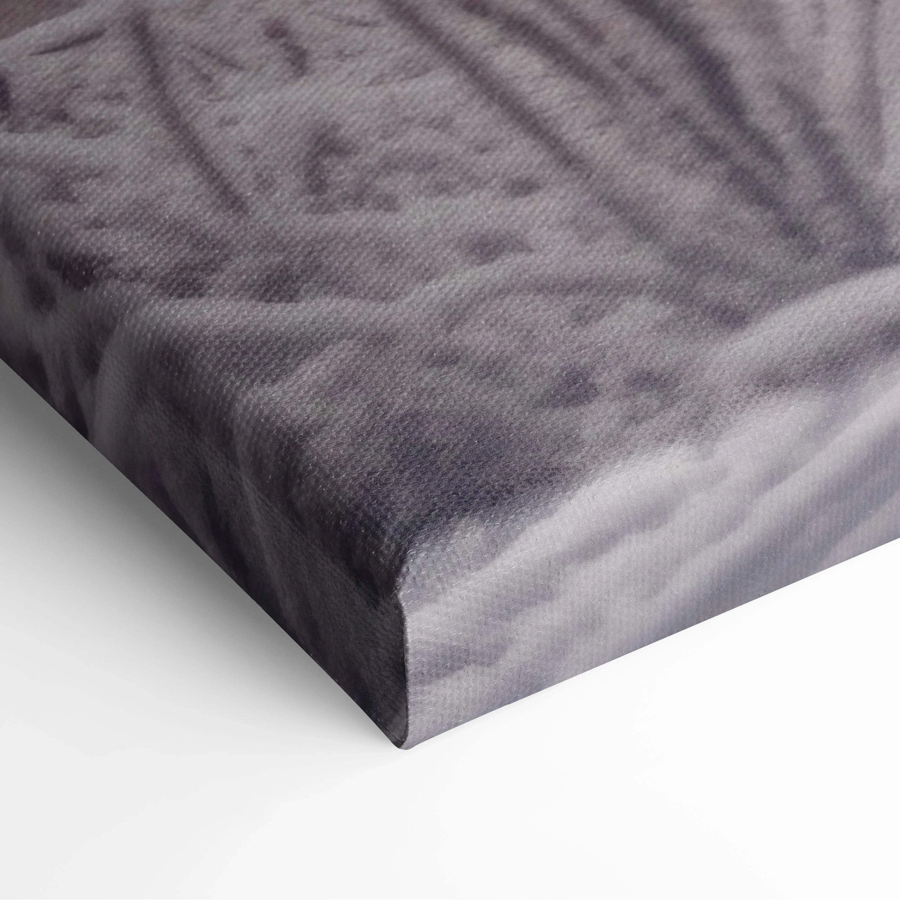 Close-up of textured canvas corner featuring muted purple and gray winter landscape print with snowy details.