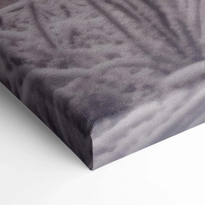 Close-up of textured canvas corner featuring muted purple and gray winter landscape print with snowy details.