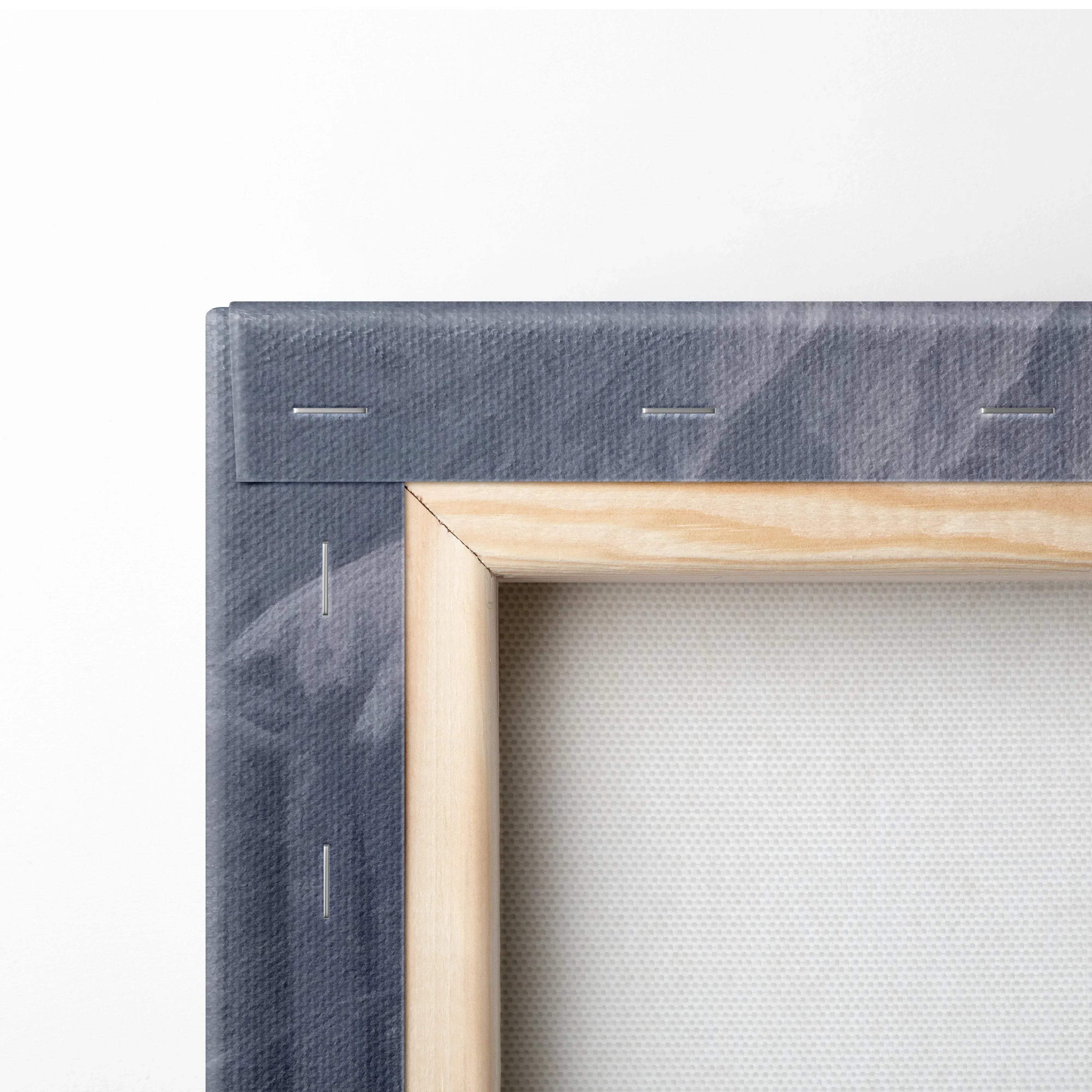 Close-up of wooden stretcher frame and textile canvas edge with dark blue and white abstract design for wall art decor.