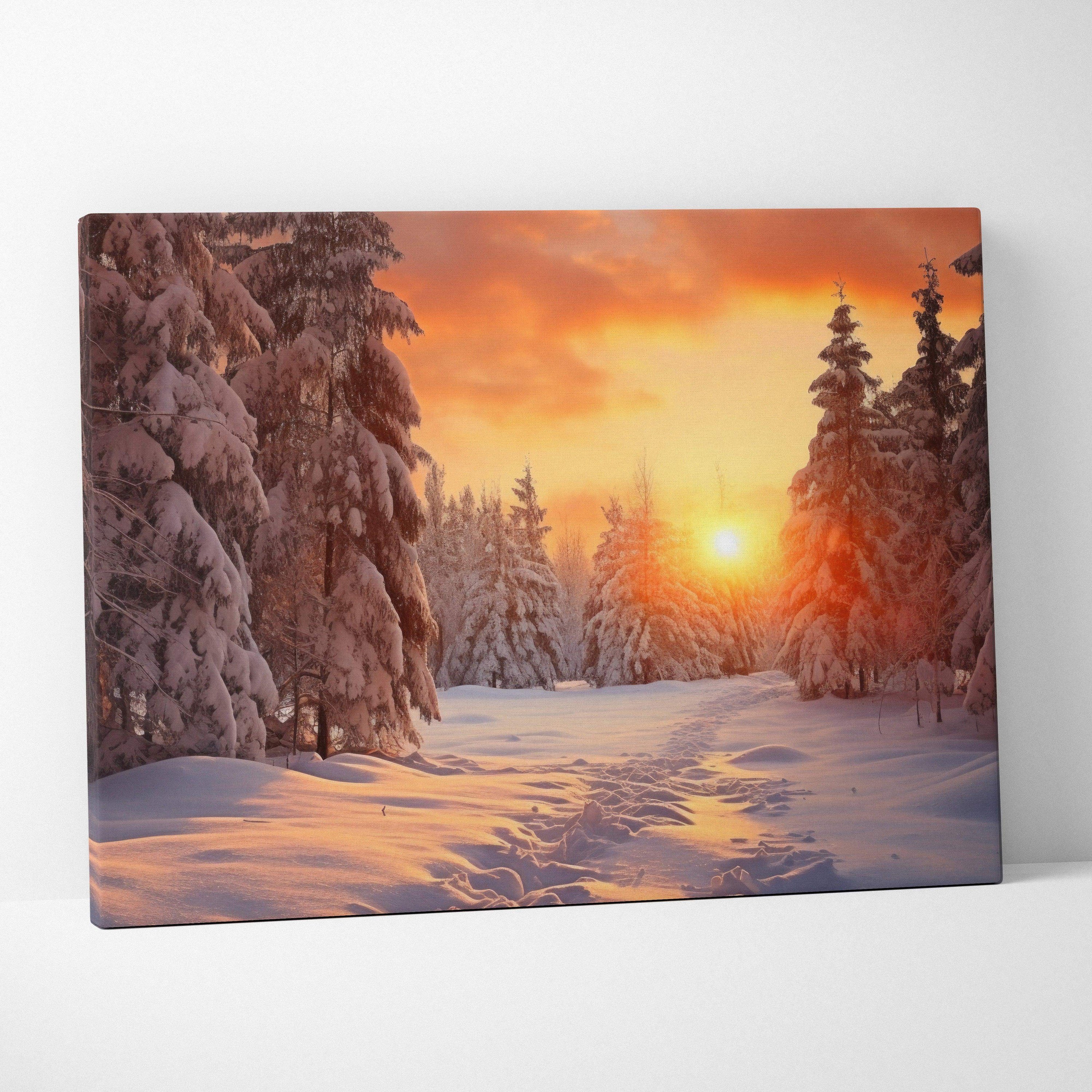 Canvas art print featuring a vivid snowy forest landscape at sunset with warm orange and yellow sky tones.