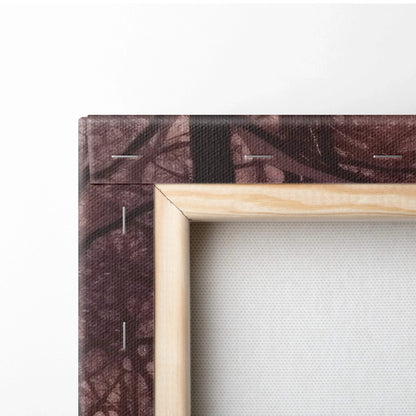 Close-up of stretched canvas wall art with wooden frame and snowy, dark purple abstract nature design.