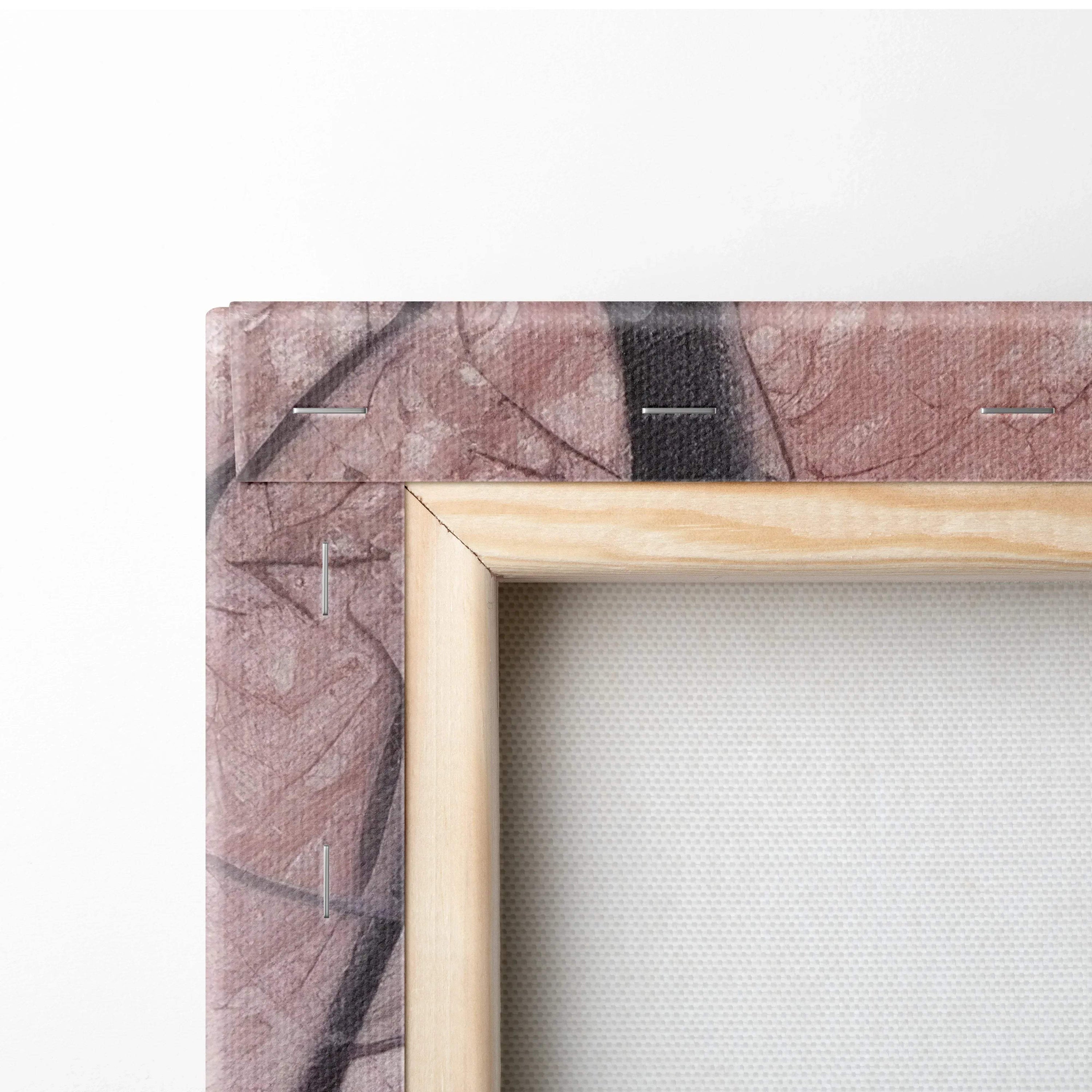 Close-up of wooden frame and stapled canvas fabric showing textured snowy bridge artwork edges.