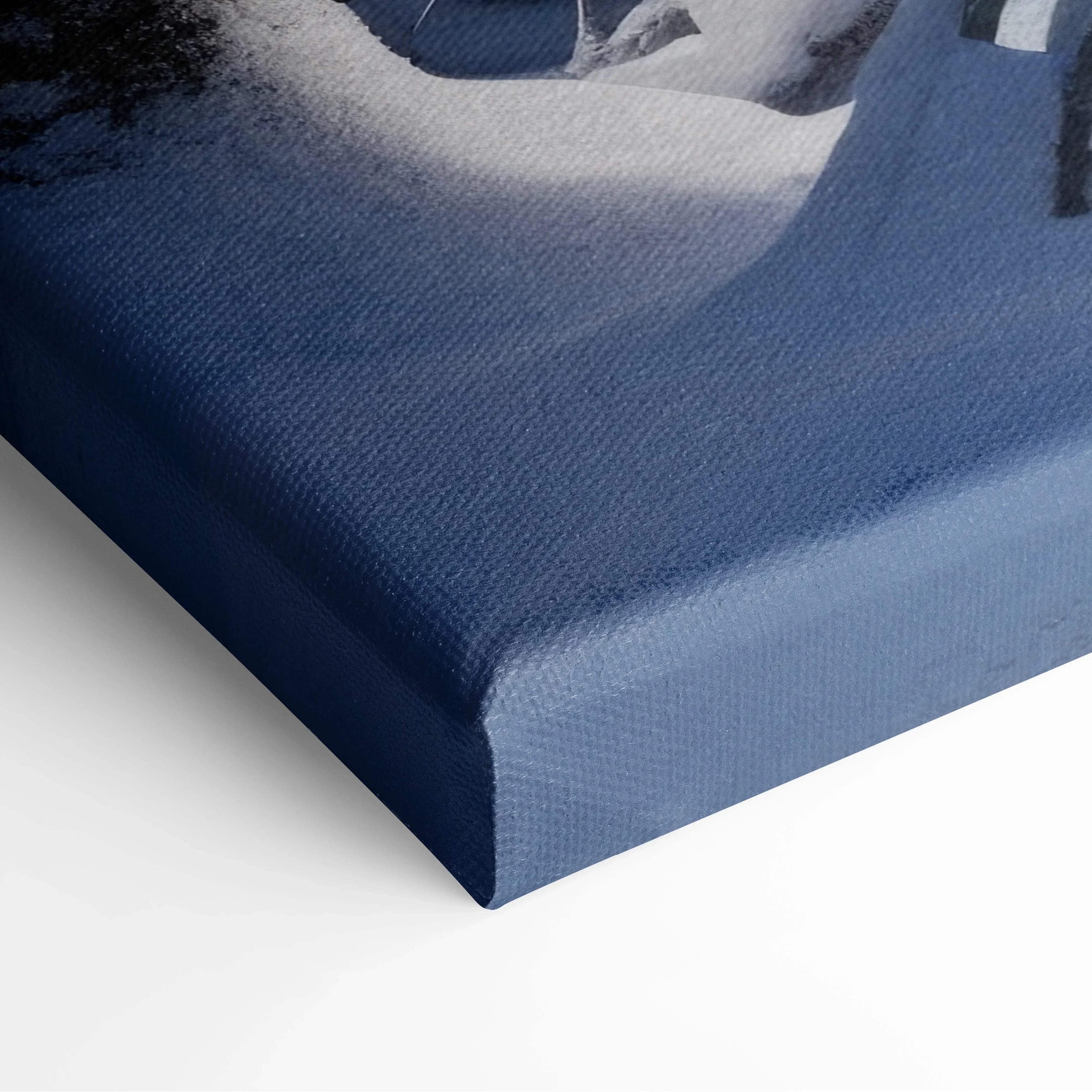 Blue canvas print with textured surface featuring a dreamy winter forest of snowy pines in tranquil azure tones