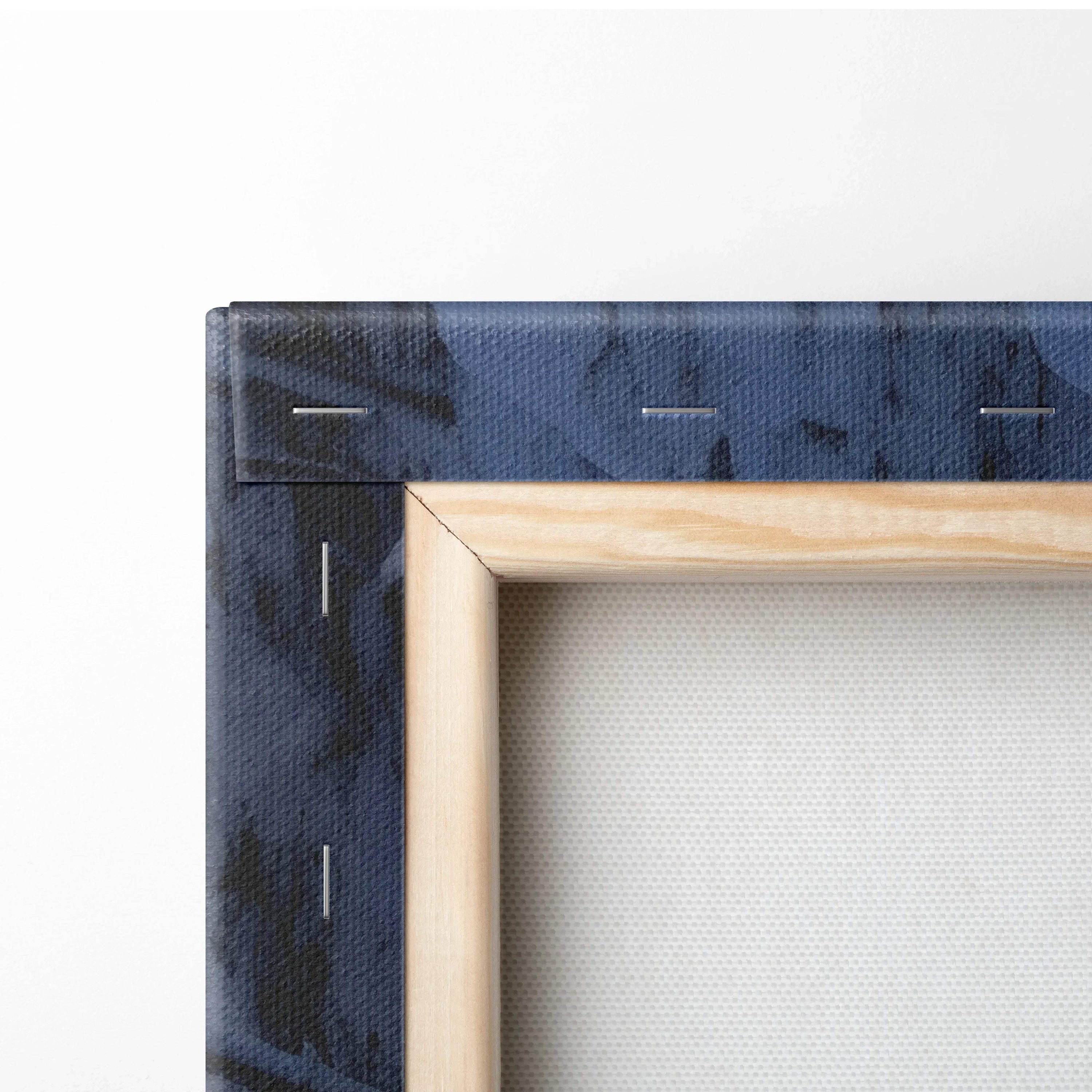 Close-up of wooden frame corner and stapled snowy forest canvas for wall art decor.